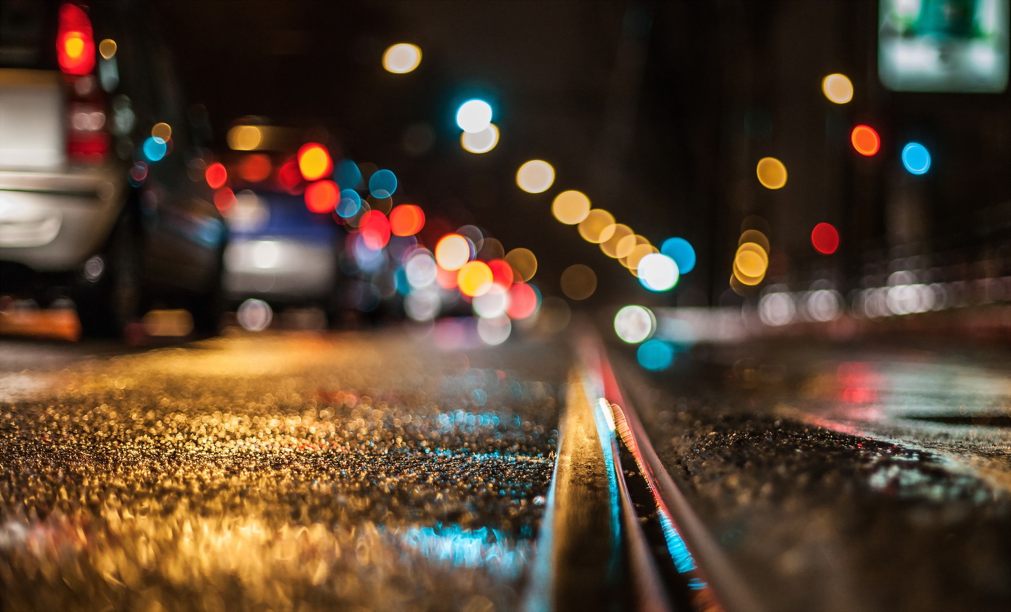Bokeh lights of traffic on a wet road at night HD Wallpaper