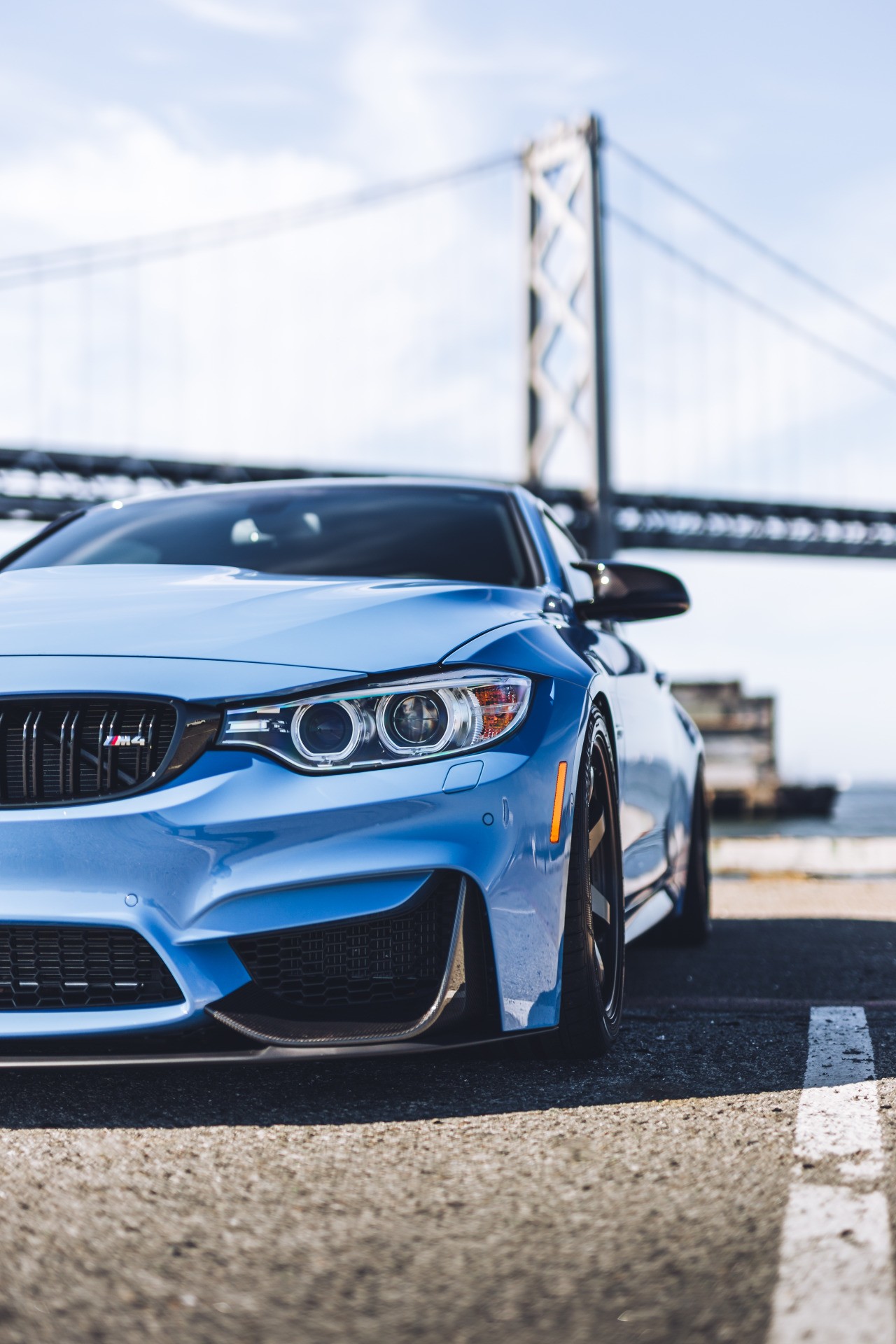 Blue BMW F82 M4 parked near a bridge HD Wallpaper