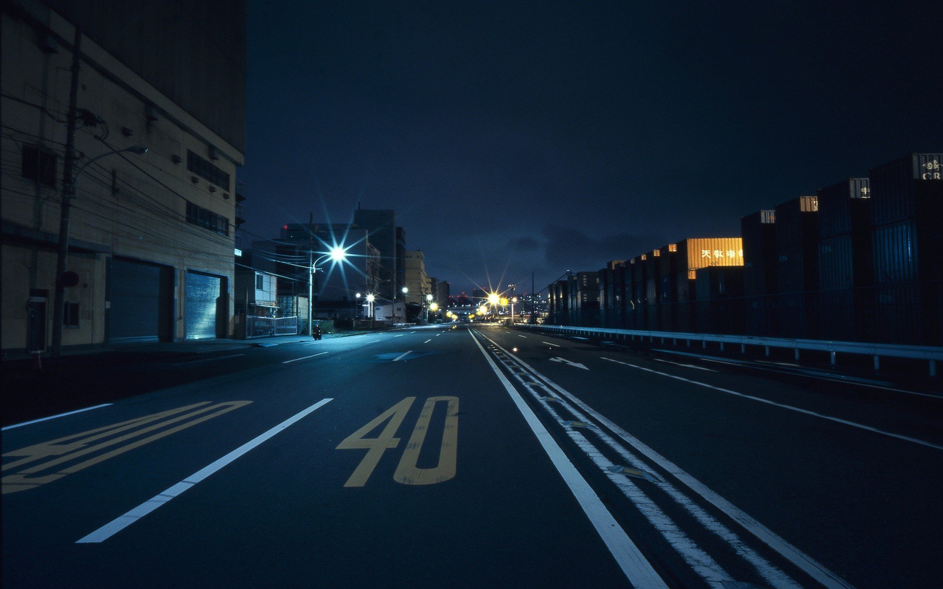 City street at night with speed limit sign HD Wallpaper