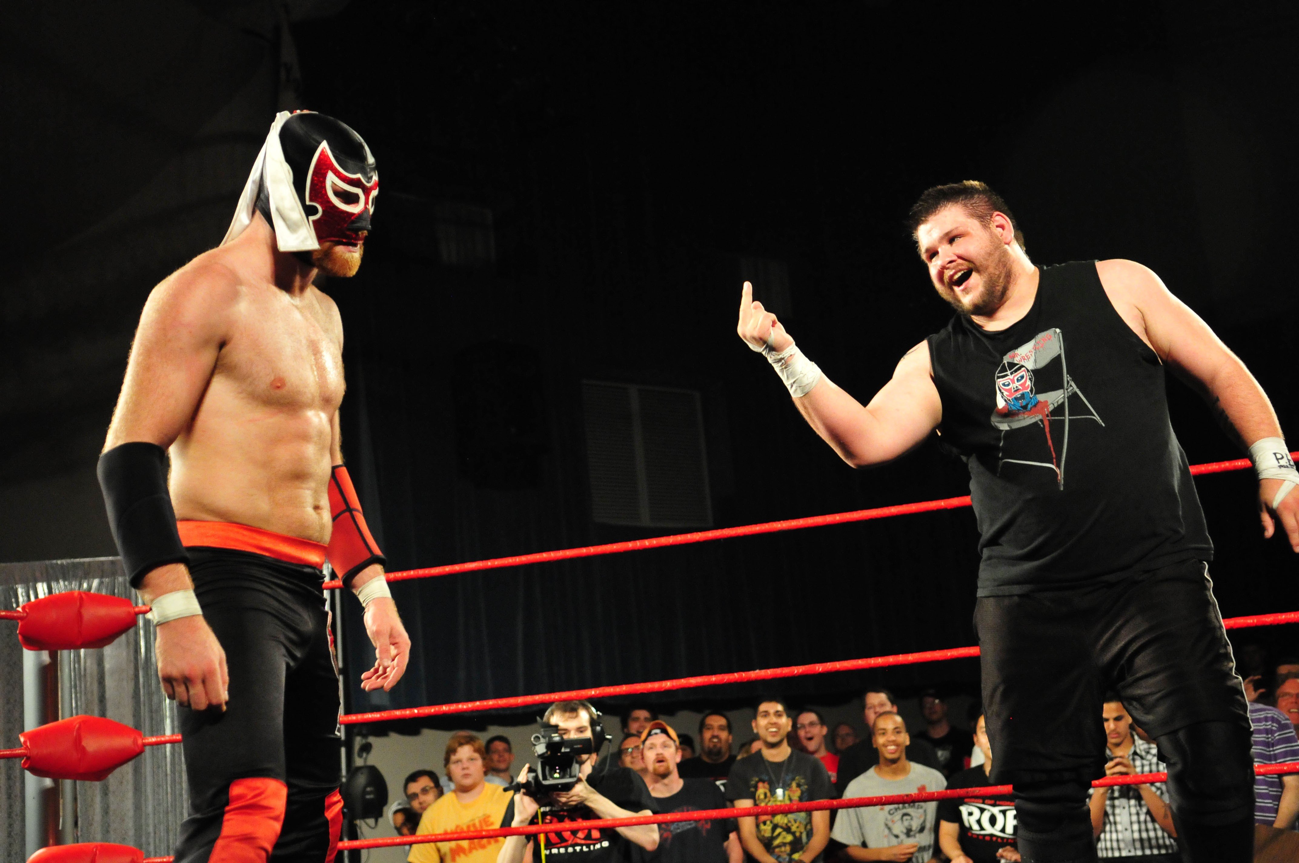 Wrestlers in a ring with audience HD Wallpaper