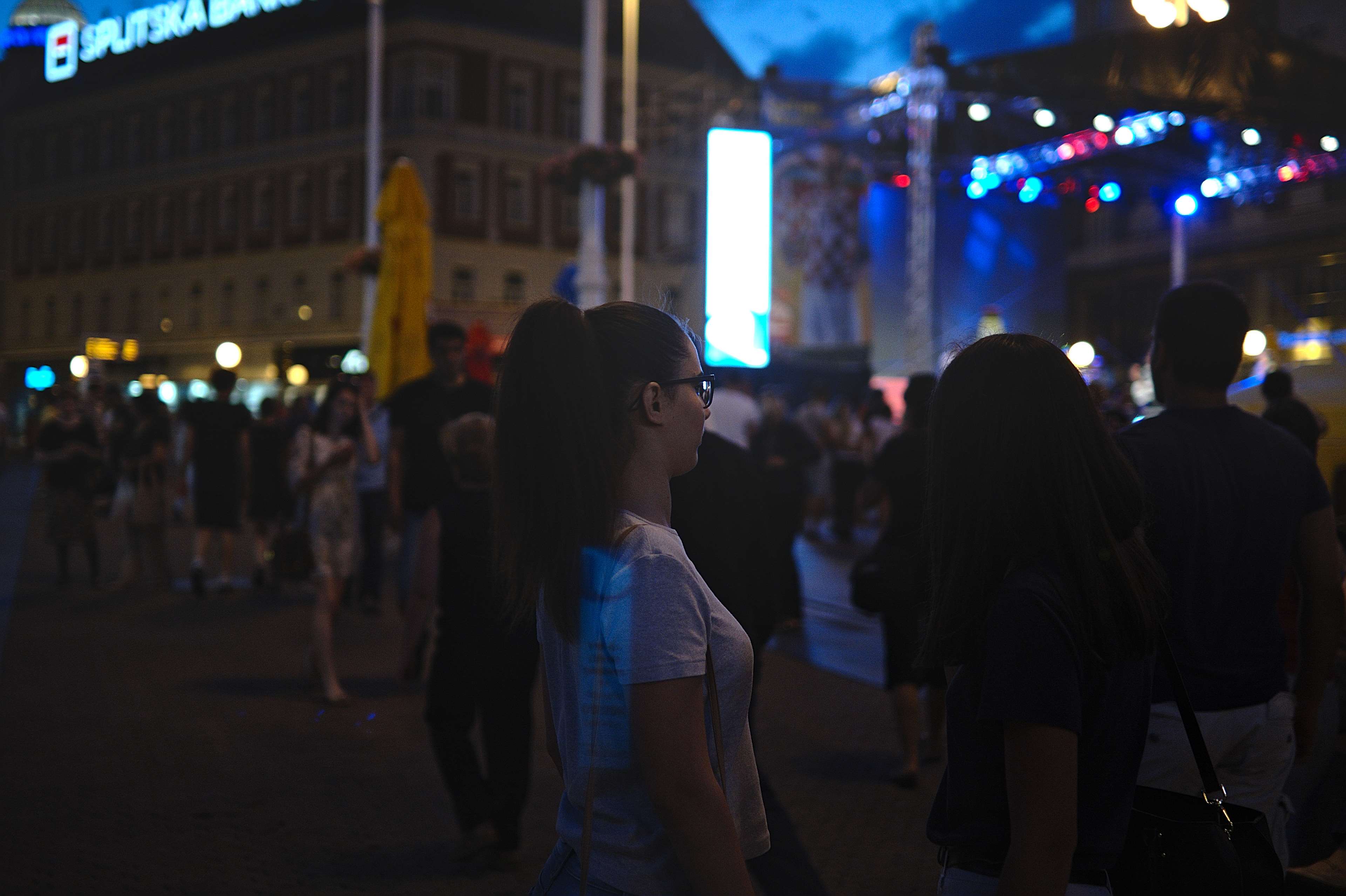 People at a night event with a stage and lights HD Wallpaper