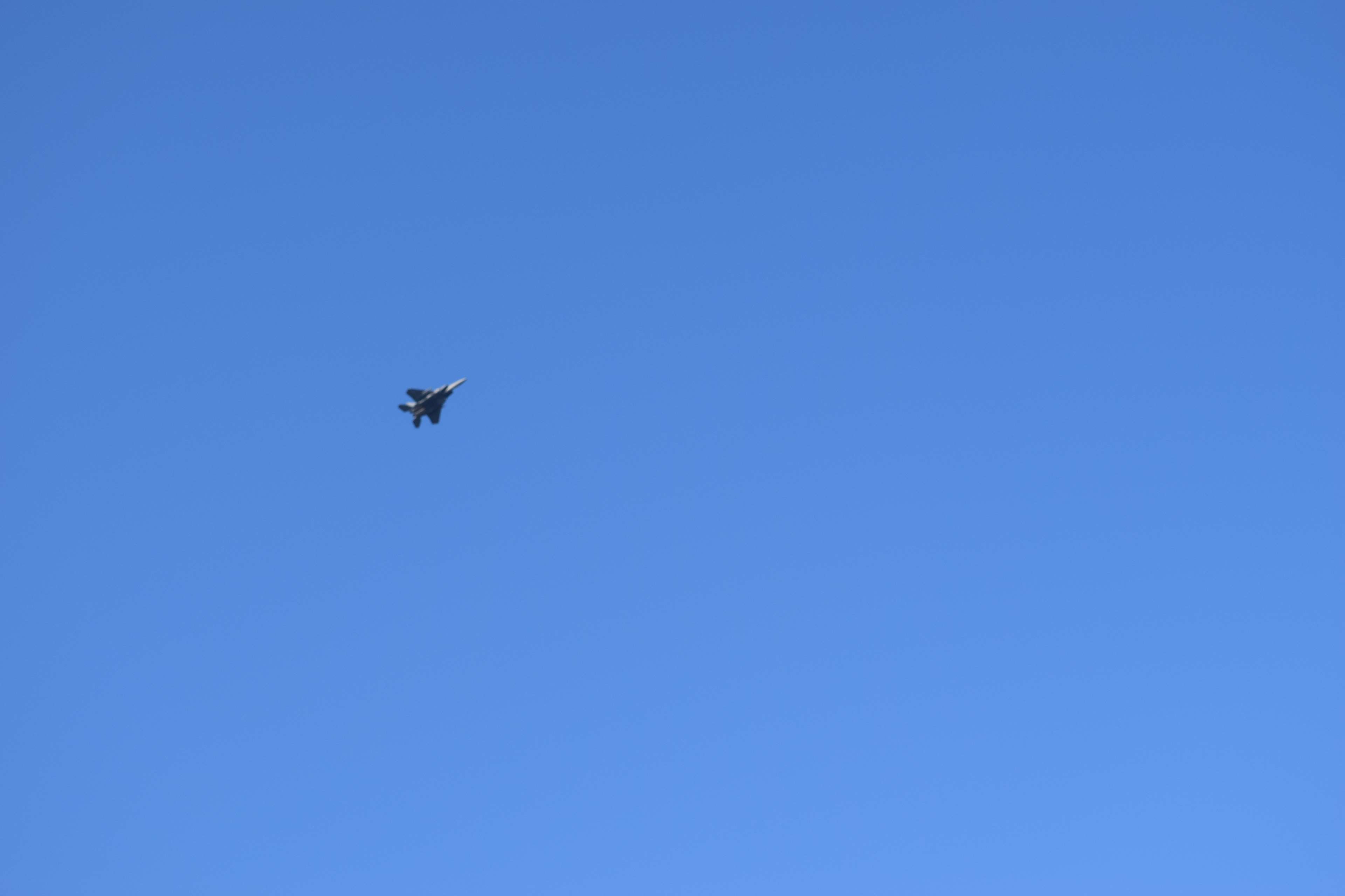 Military jet flying in a clear blue sky 4K HD Wallpaper