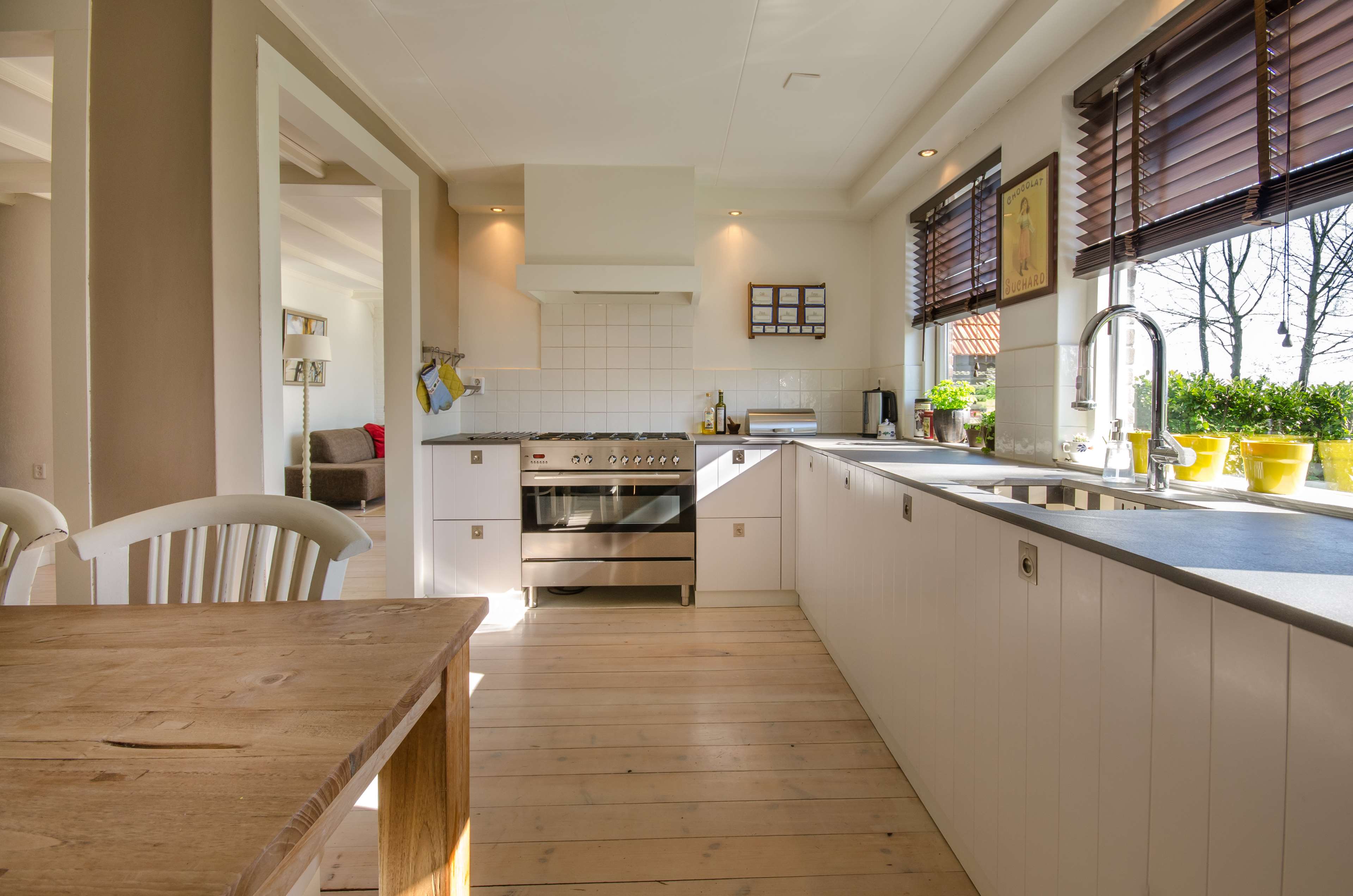 Modern kitchen with wooden table and chairs HD Wallpaper