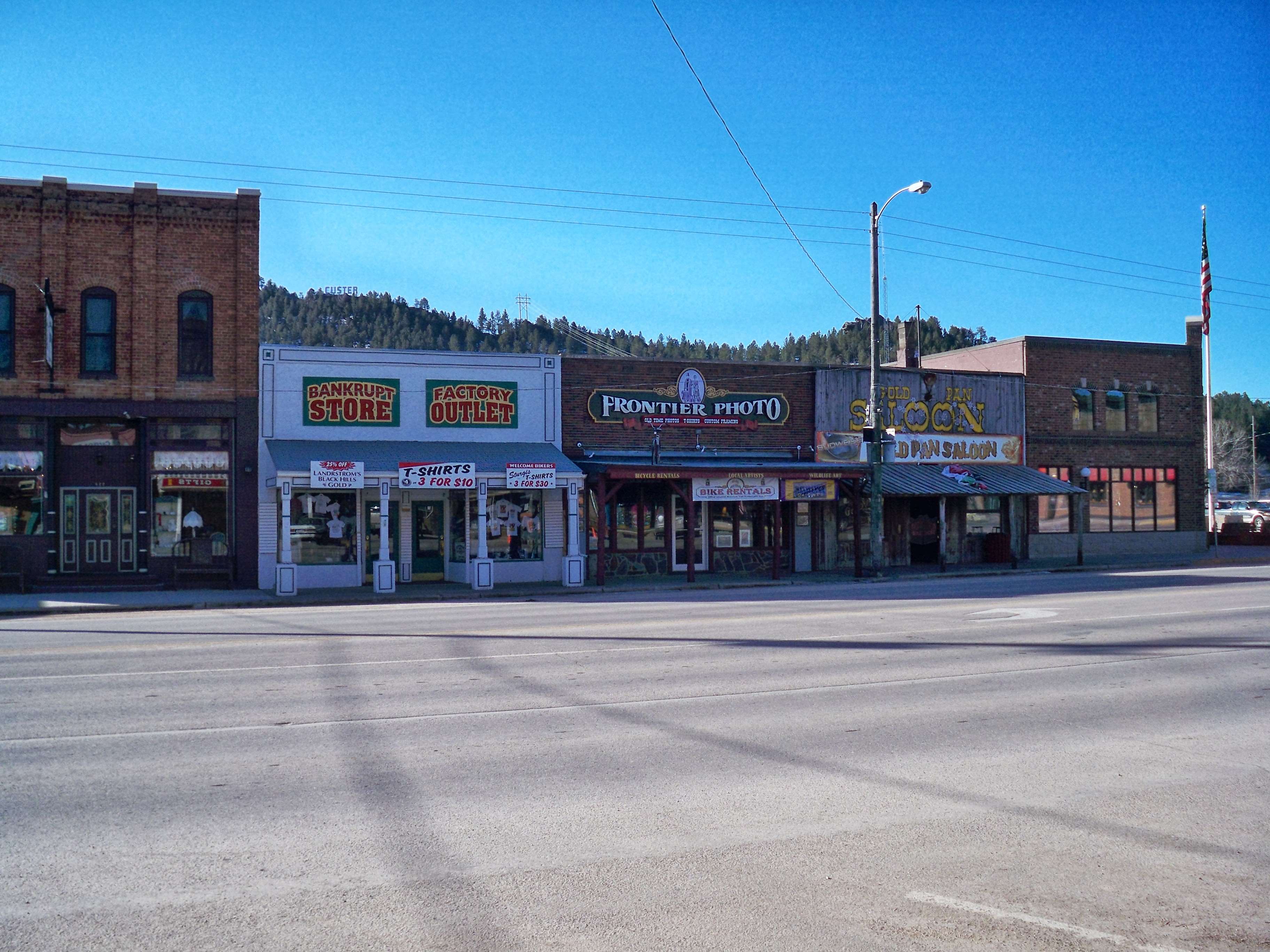 Old town street with storefronts HD Wallpaper