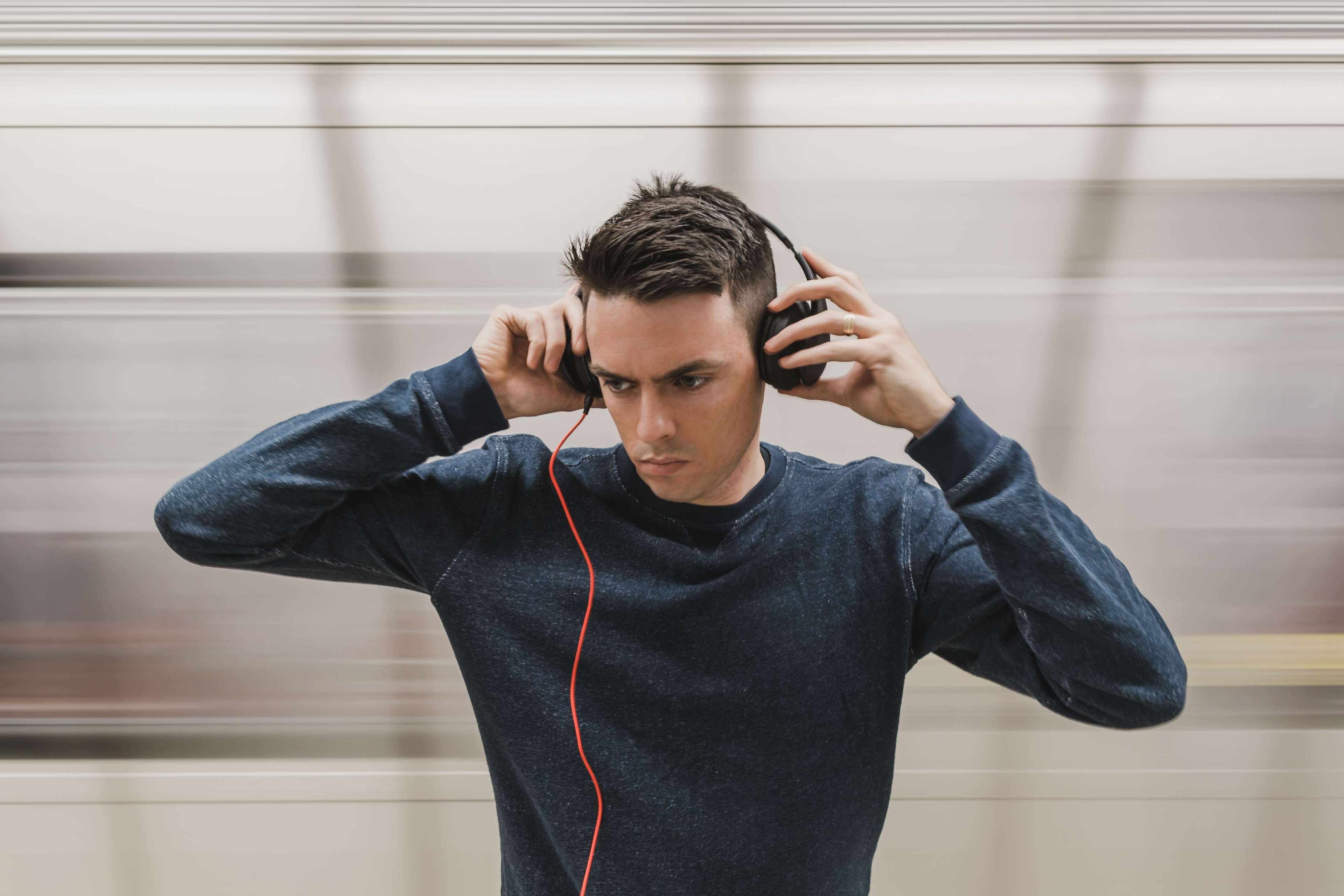 Man wearing headphones on a train HD Wallpaper