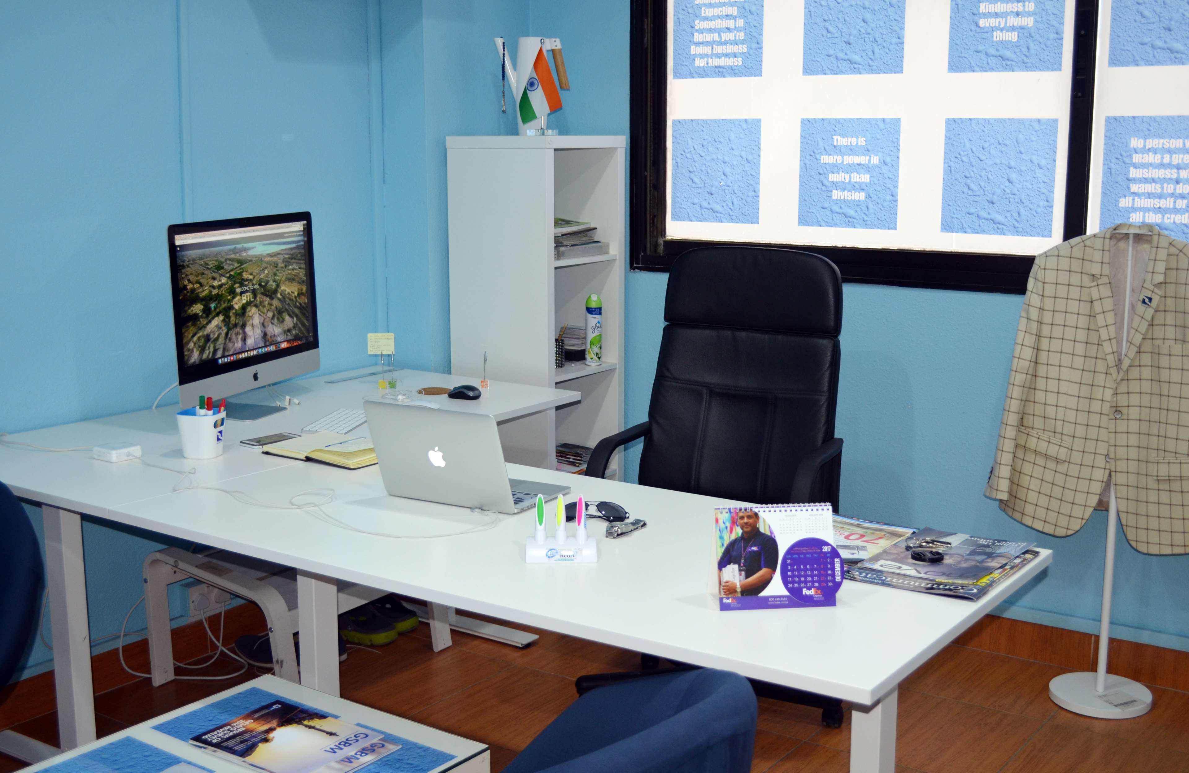 Office workspace with desk, computers, and blazer HD Wallpaper
