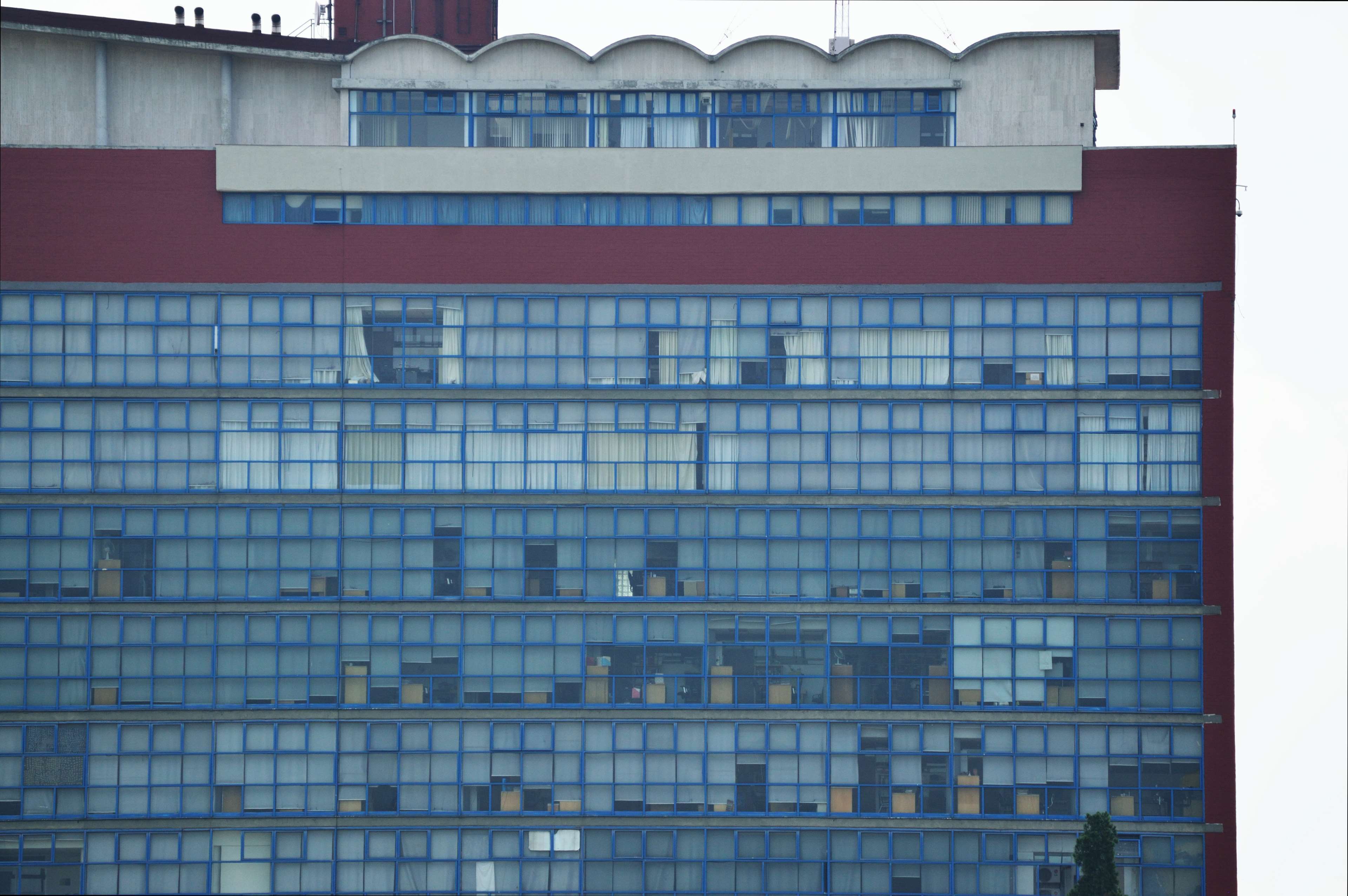 Modern office building with blue grid windows HD Wallpaper