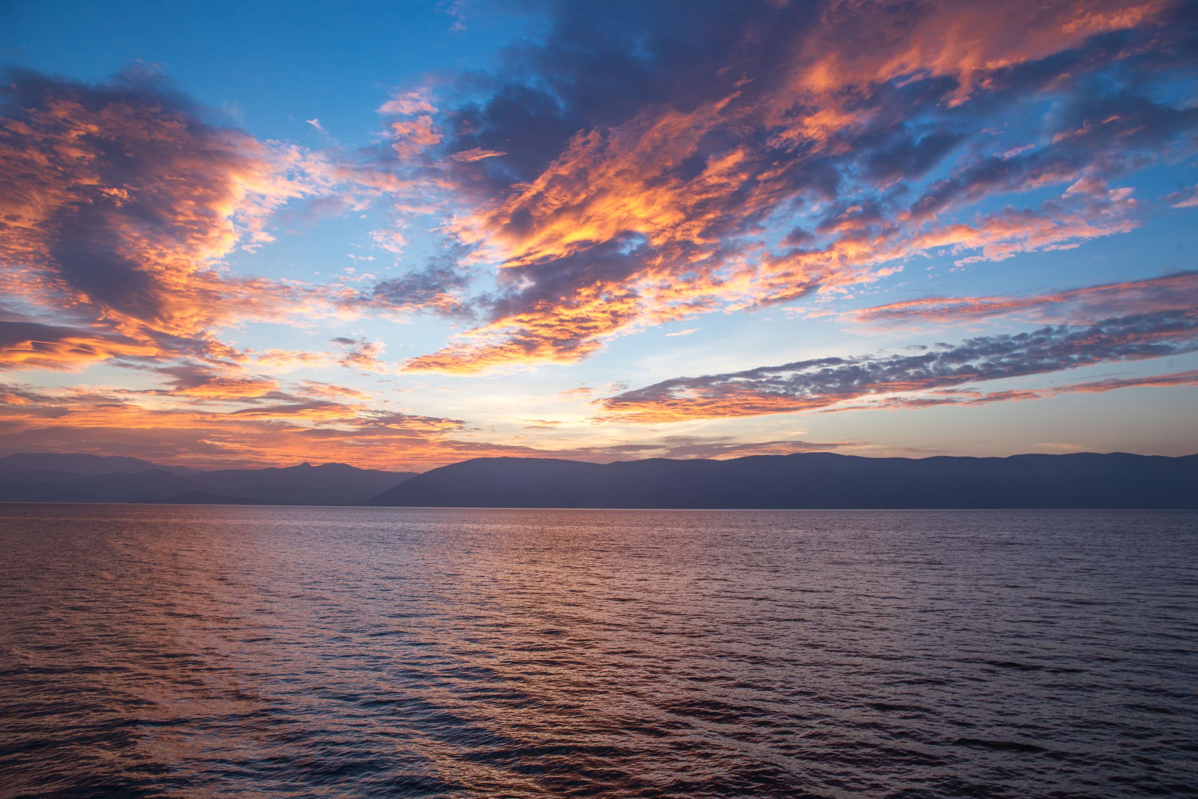 Sunset over the ocean with colorful clouds HD Wallpaper