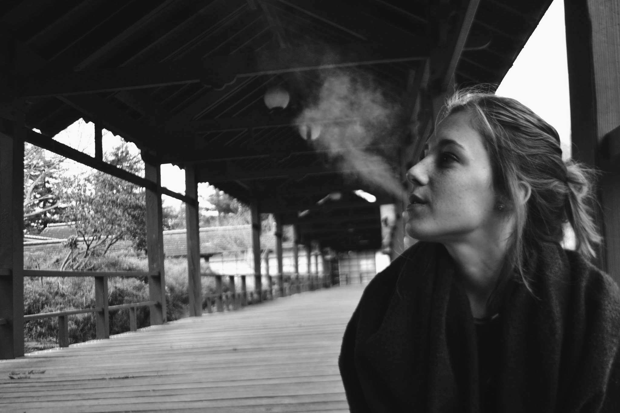 Girl smoking on a wooden bridge HD Wallpaper