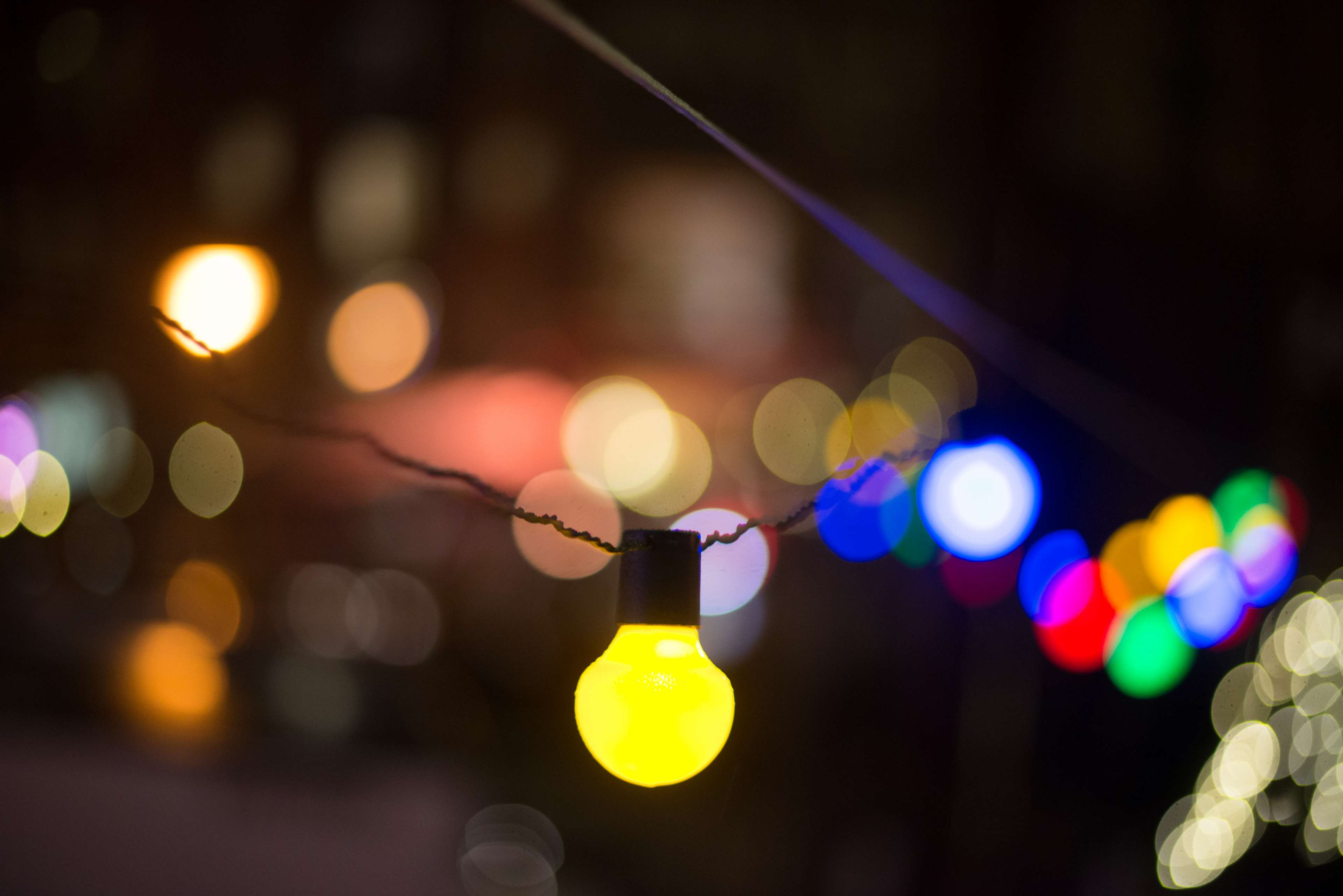 Close up of illuminated string lights at night HD Wallpaper