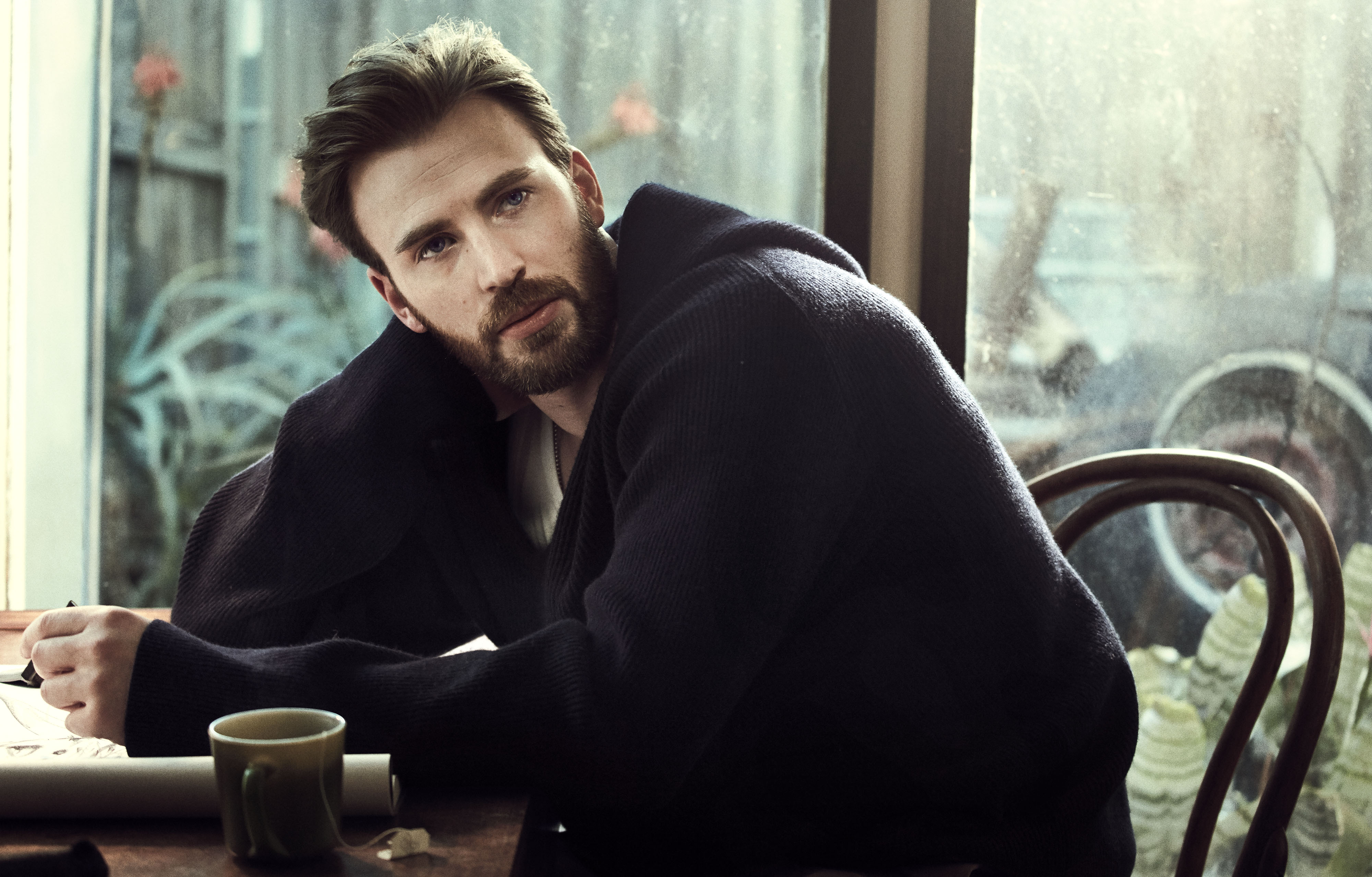 Chris Evans sitting at a table HD Wallpaper