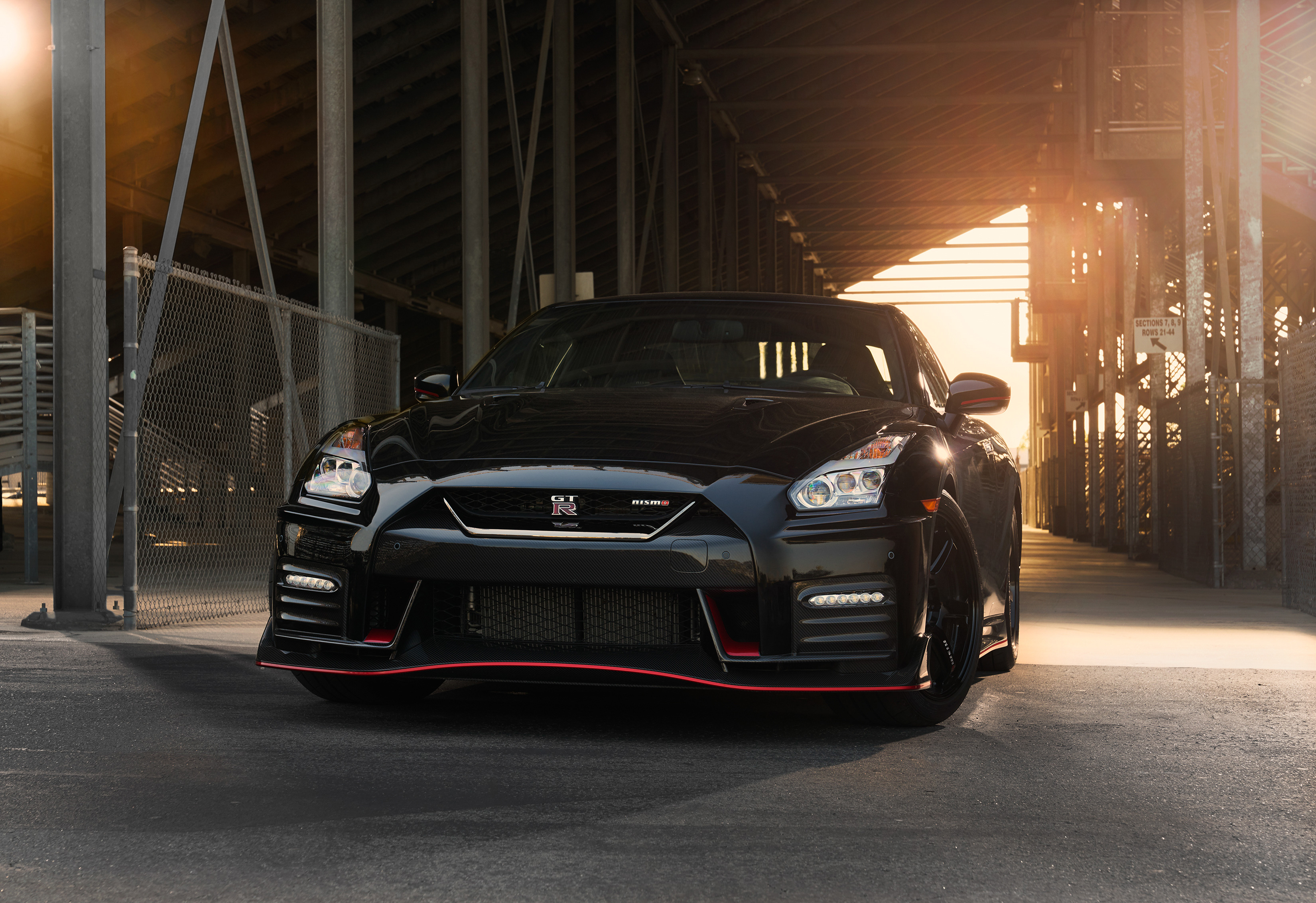 Black Nissan GT-R Nismo parked under a structure HD Wallpaper