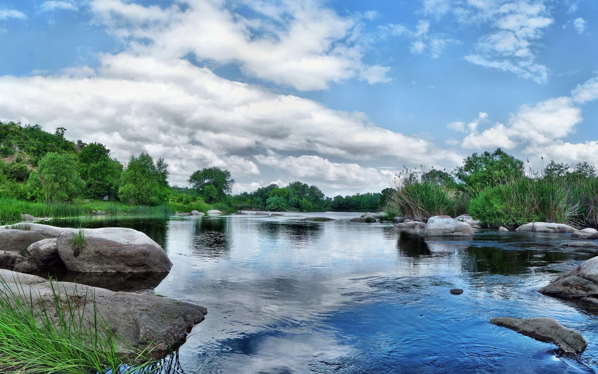 River with rocks and trees under a cloudy sky HD Wallpaper