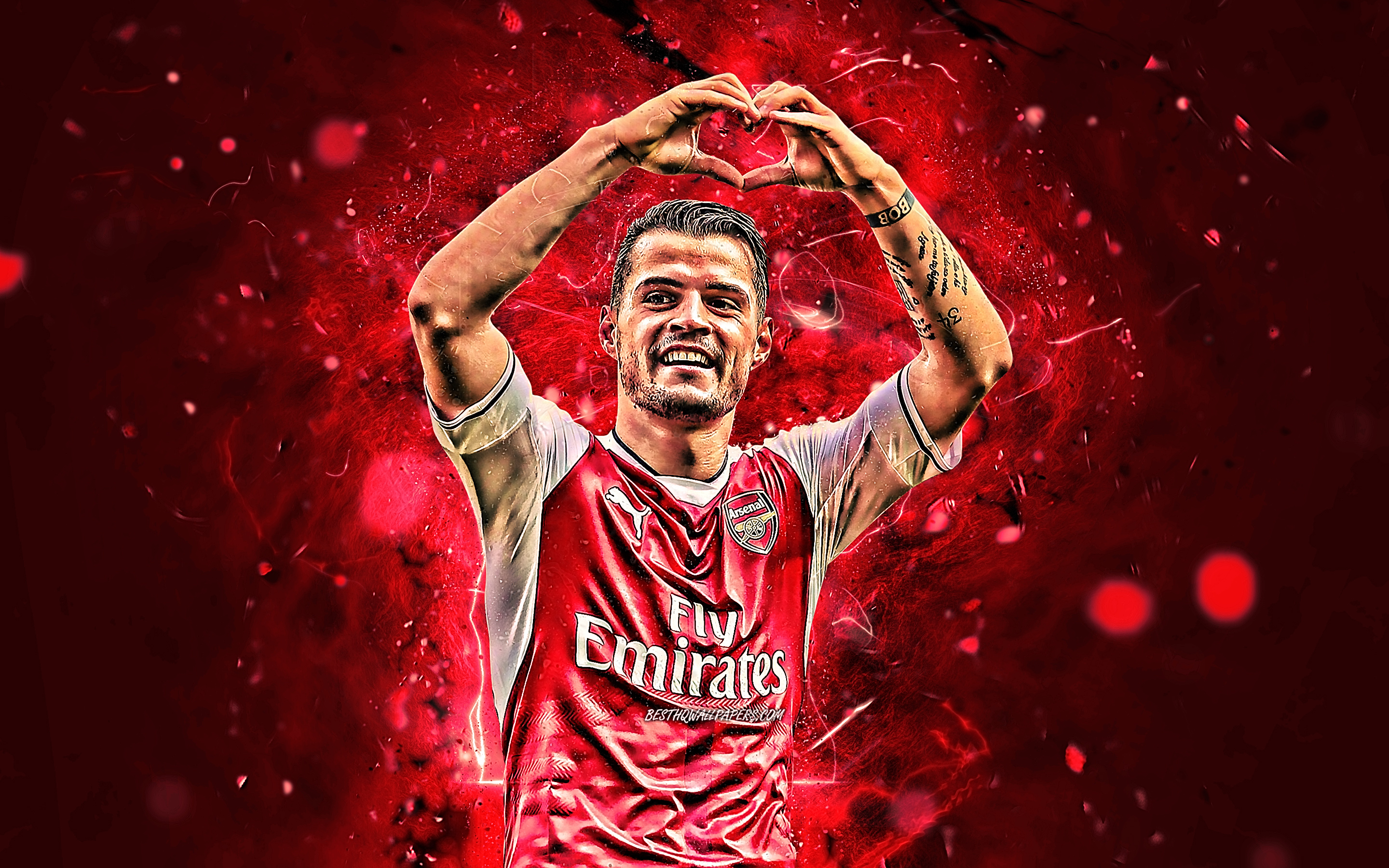 Granit Xhaka of Arsenal F.C. making a heart shape HD Wallpaper