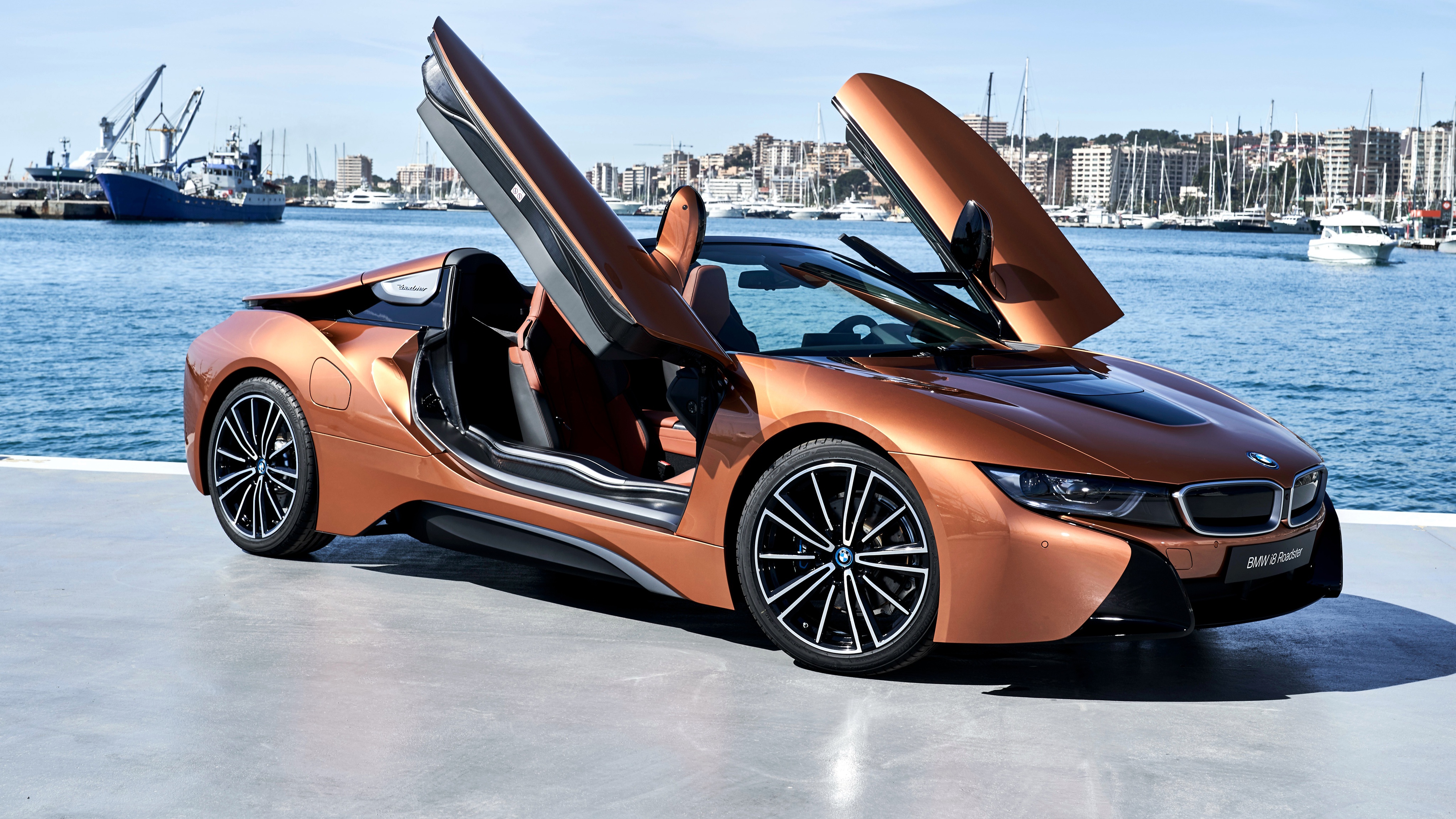 Orange BMW i8 Roadster parked by the water HD Wallpaper