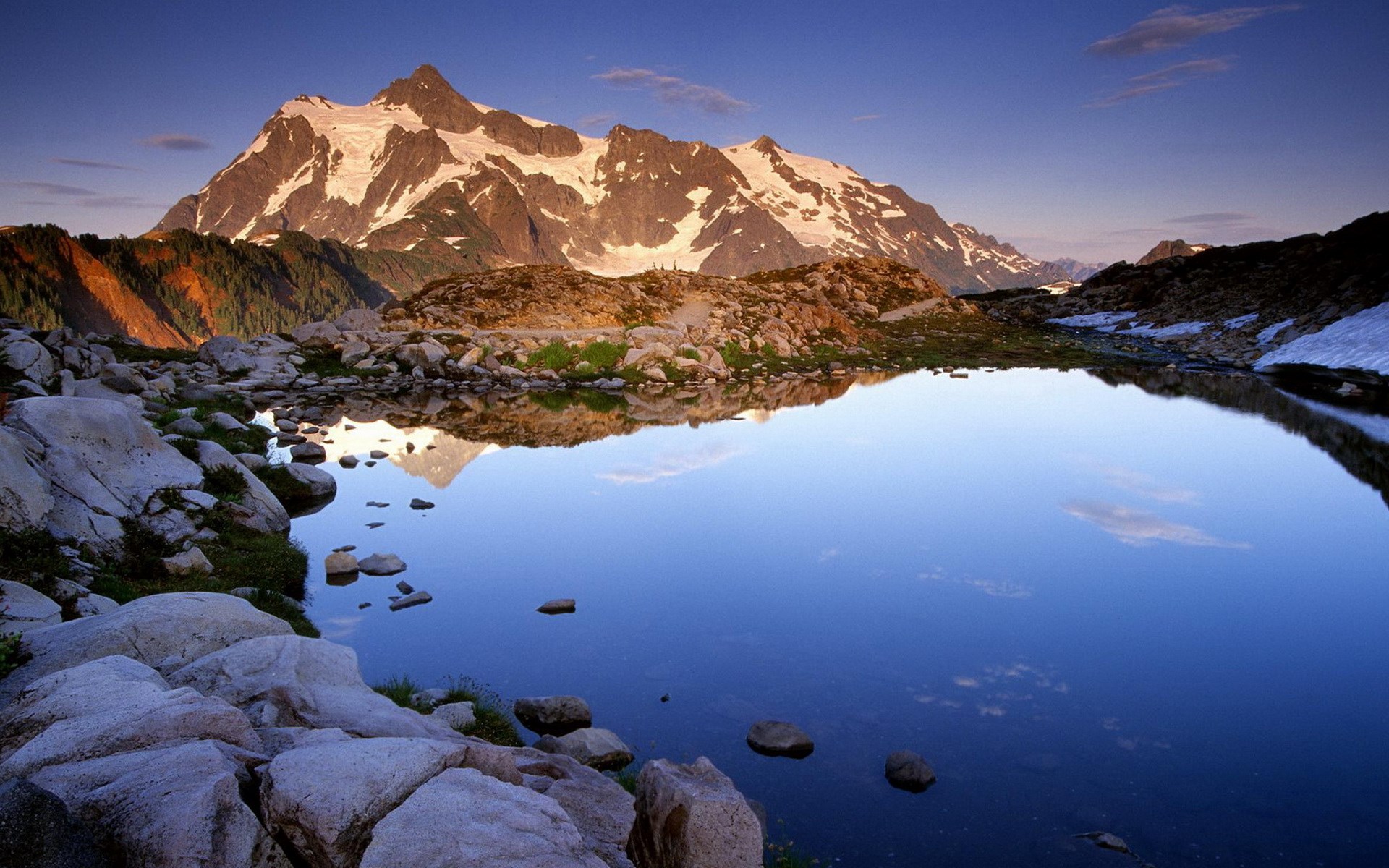 Snow-capped mountains reflected in a calm lake HD Wallpaper
