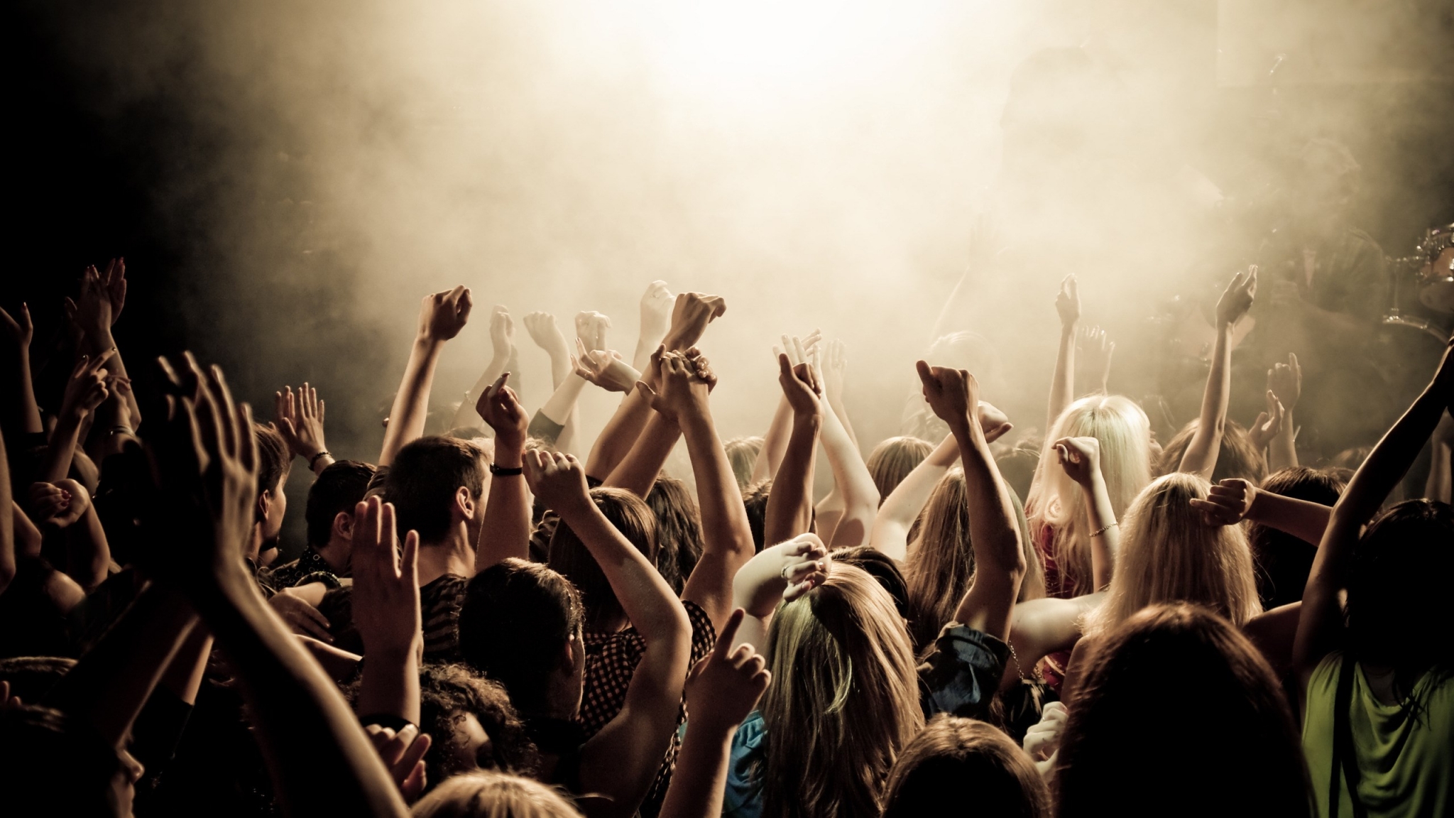 Crowd with hands raised at a concert HD Wallpaper