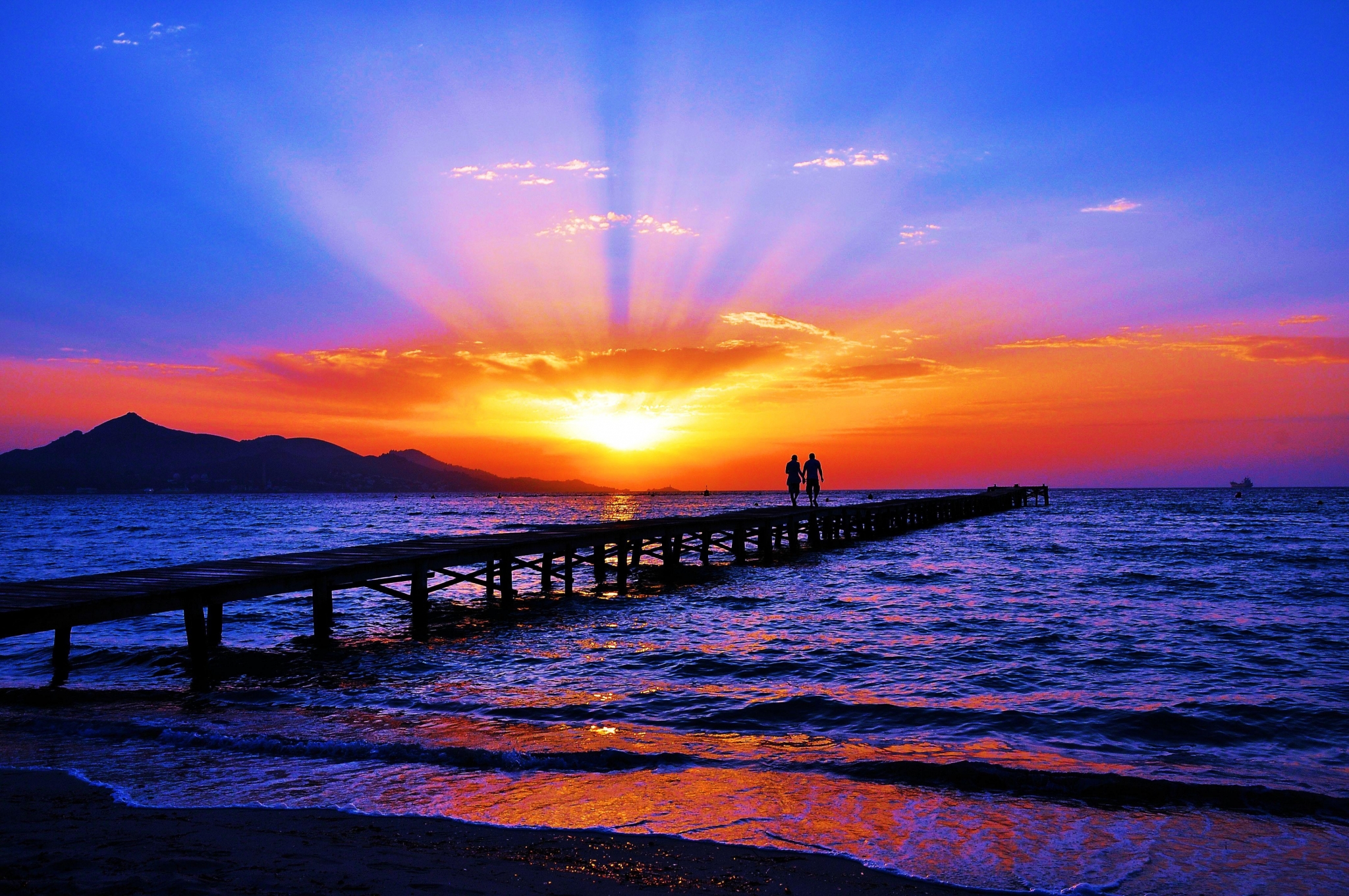 Couple walking on pier during sunset HD Wallpaper