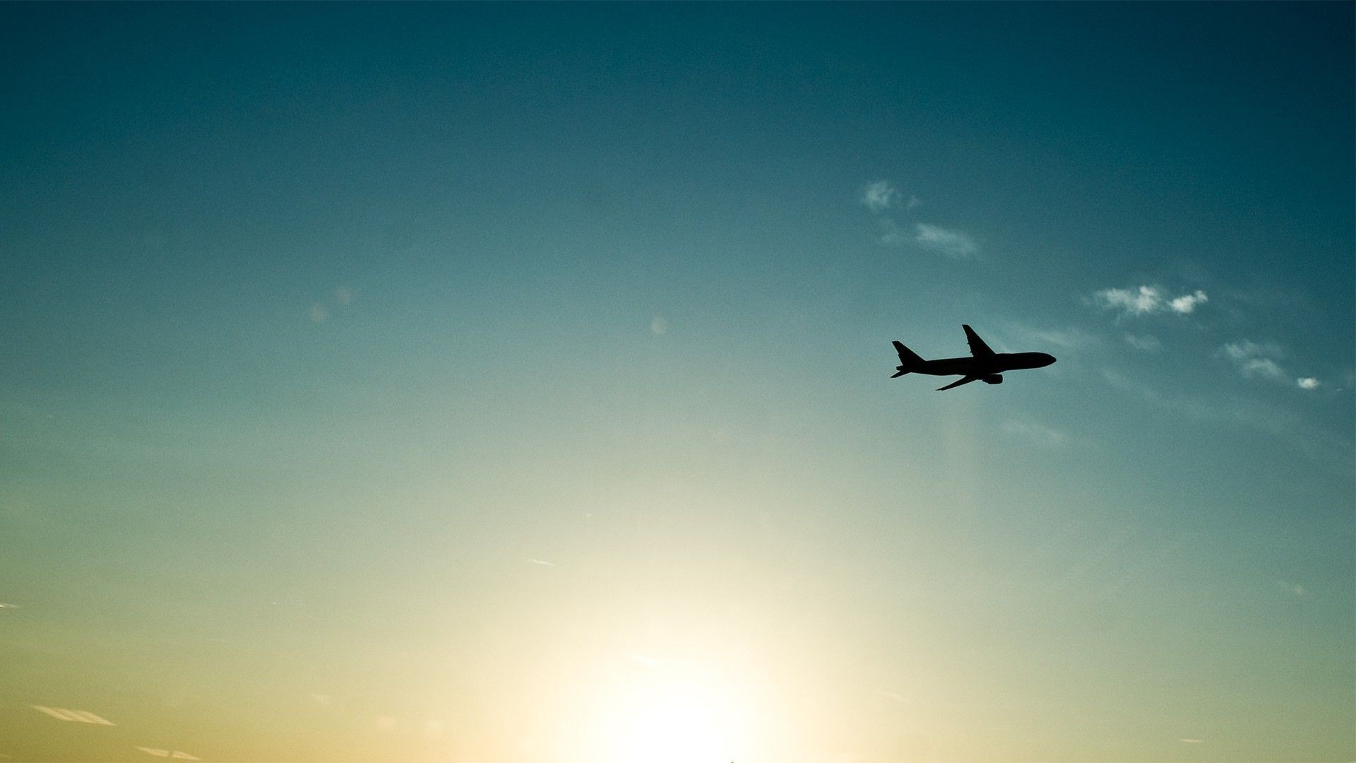 Airplane flying in the sky at sunset HD Wallpaper