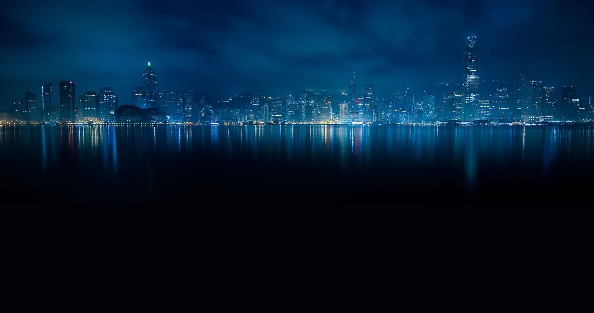 City skyline at night reflected in water HD Wallpaper