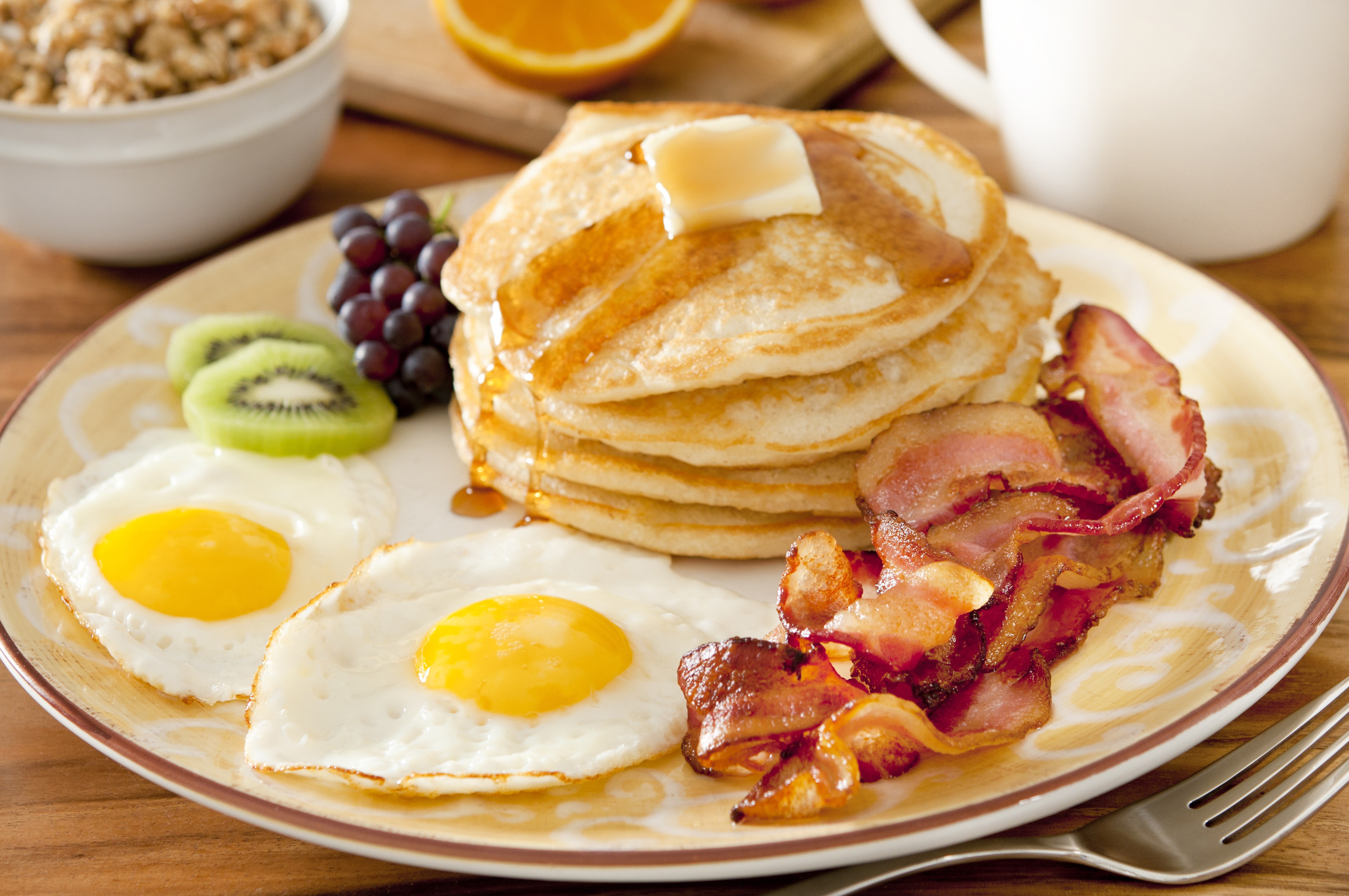 Breakfast plate with pancakes, eggs, bacon, and fruit HD Wallpaper