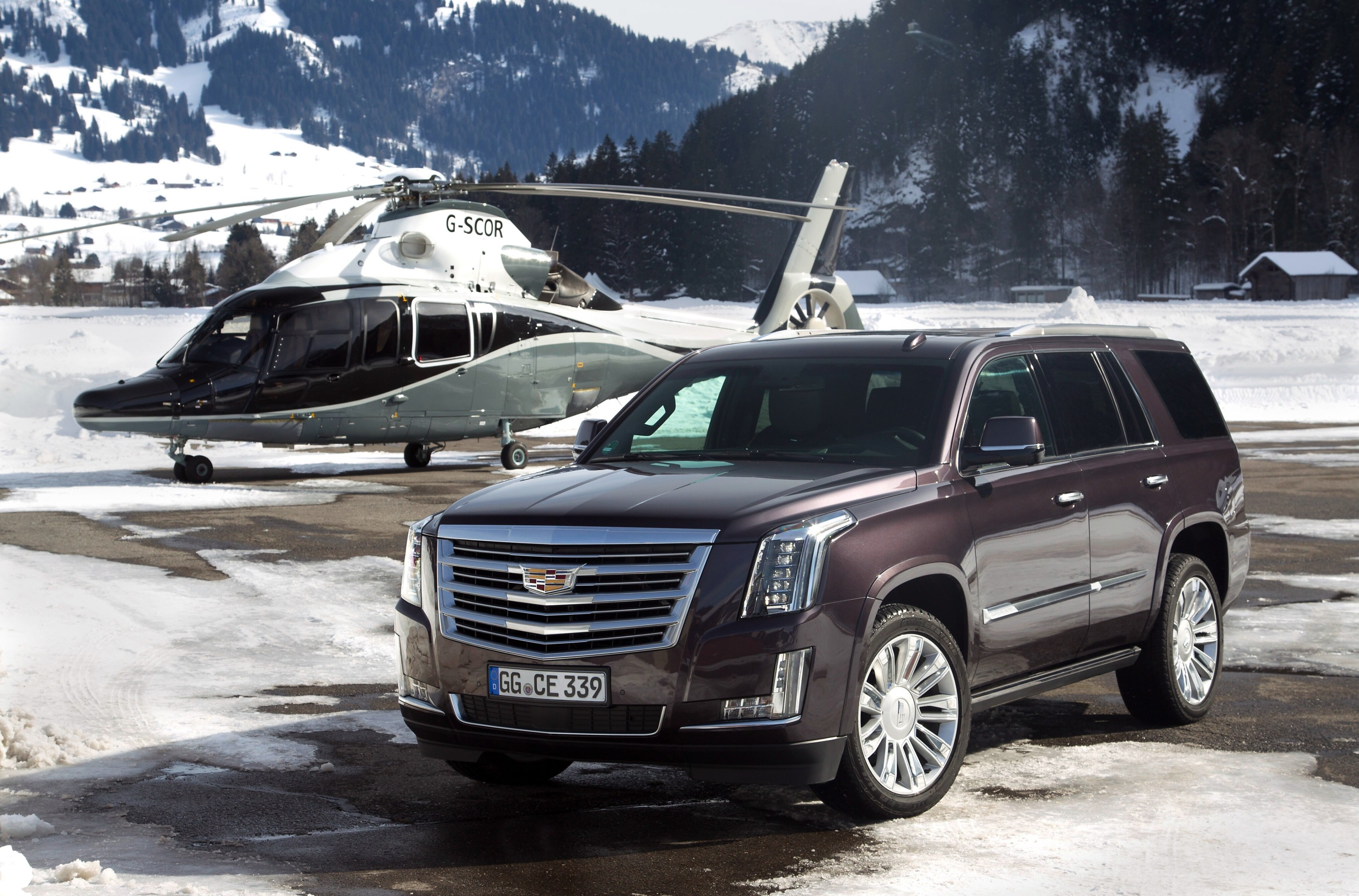 Cadillac Escalade and Helicopter in Snowy Mountains HD Wallpaper