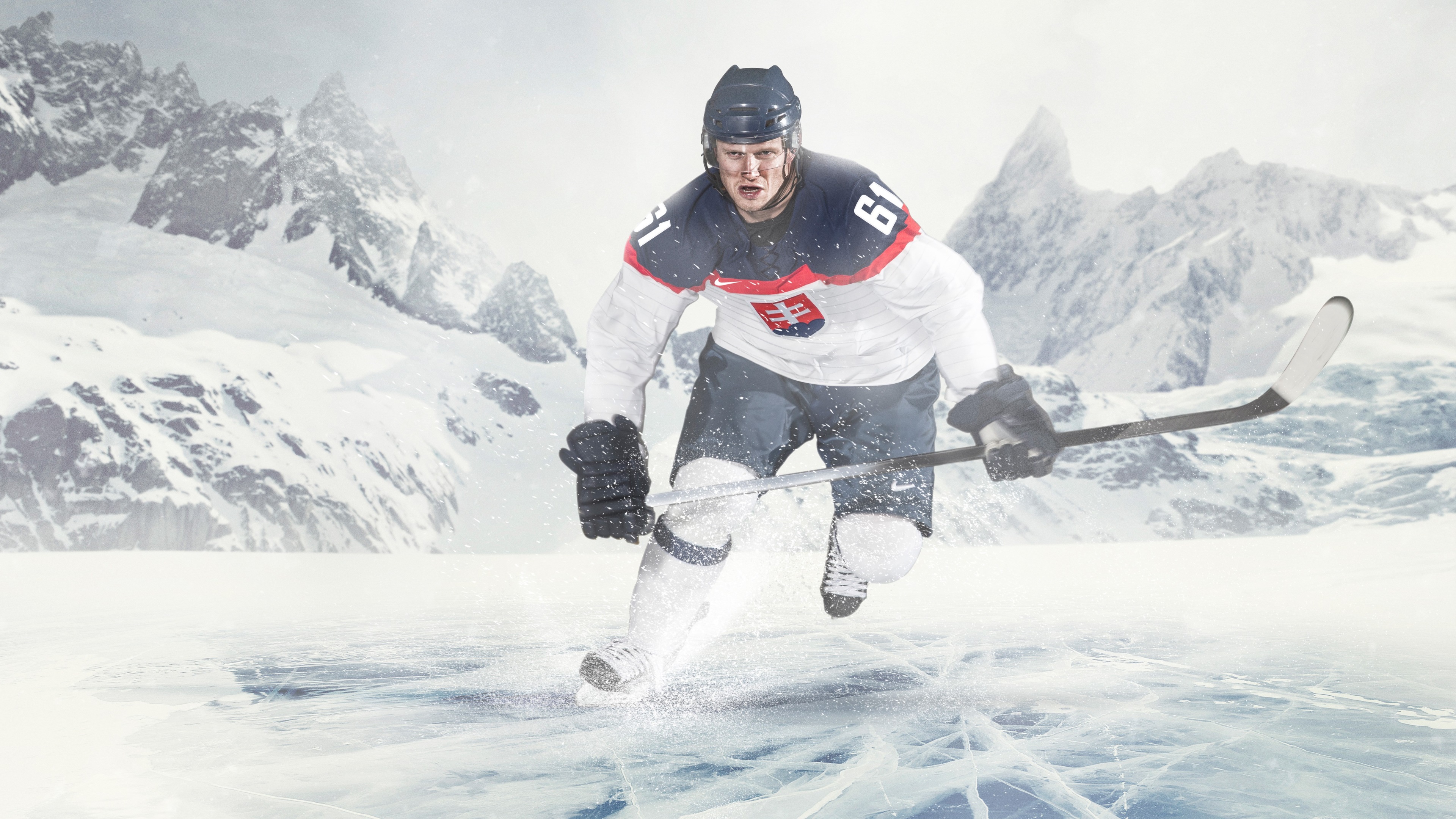 Ice Hockey Player in Snowy Mountains HD Wallpaper