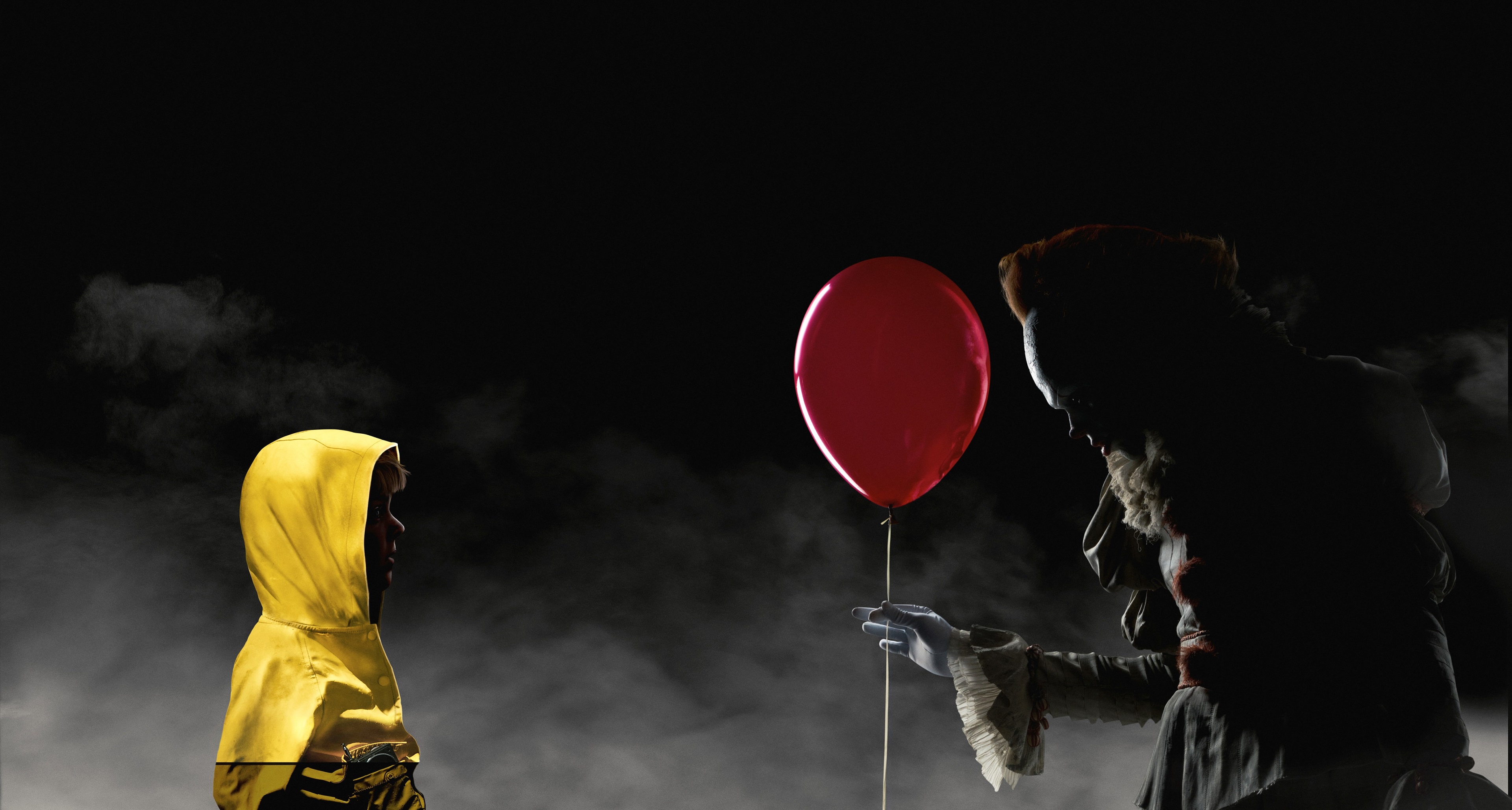 Pennywise the Dancing Clown from It offers a balloon to a child HD Wallpaper