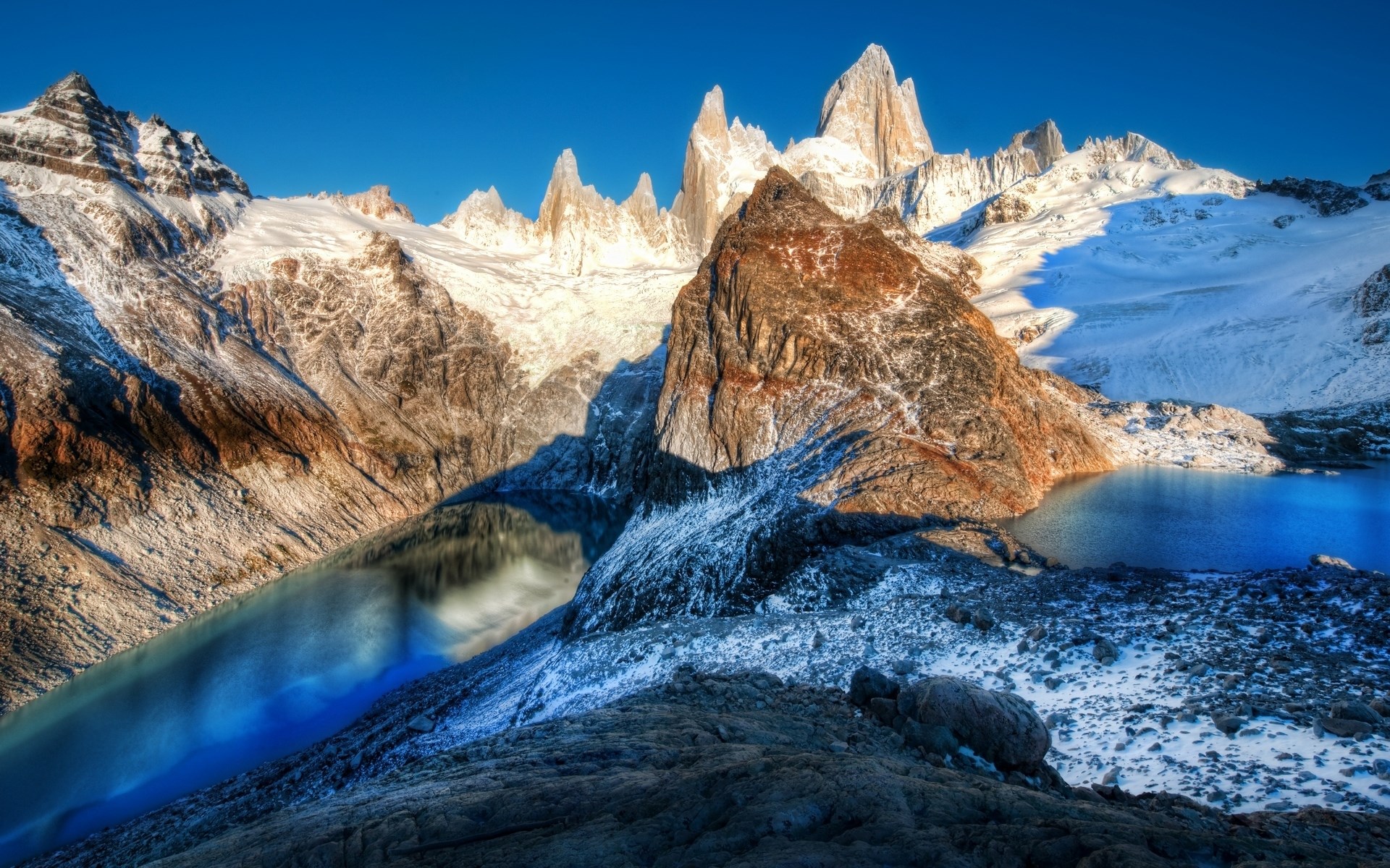 Snow-capped mountains and a blue lake HD Wallpaper