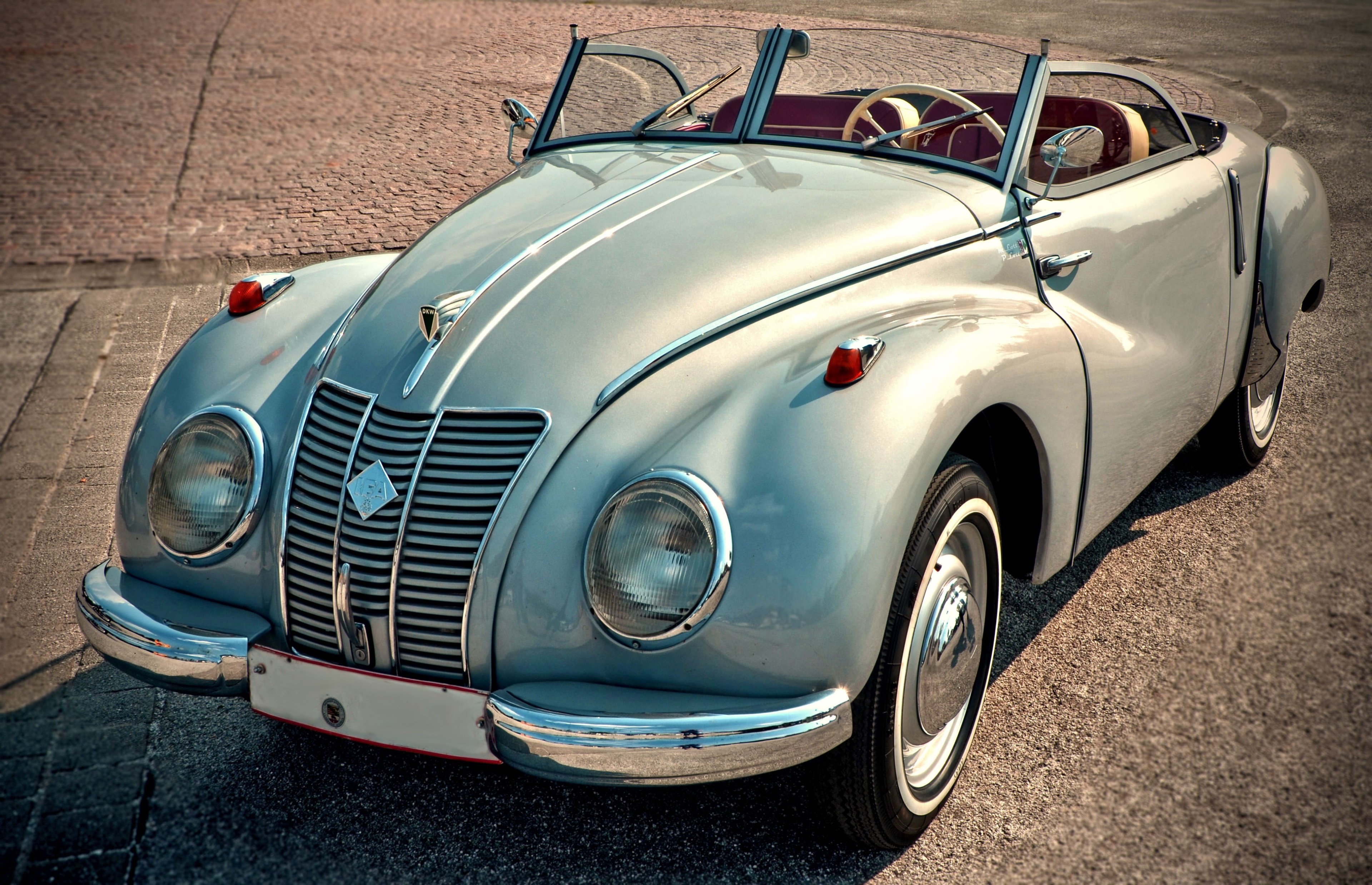 Silver convertible classic car on cobblestone street HD Wallpaper