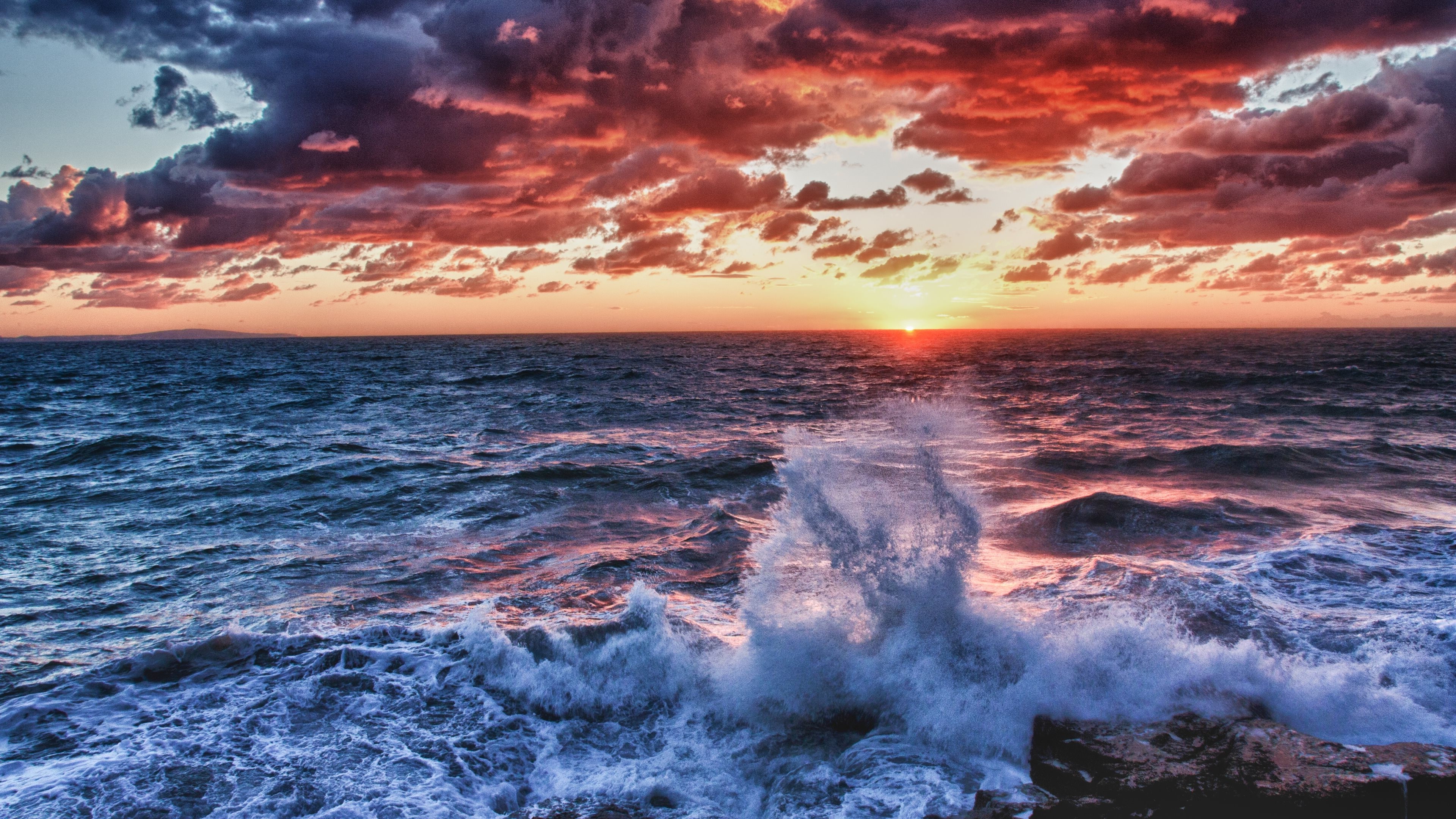 Sunset over the ocean with crashing waves HD Wallpaper
