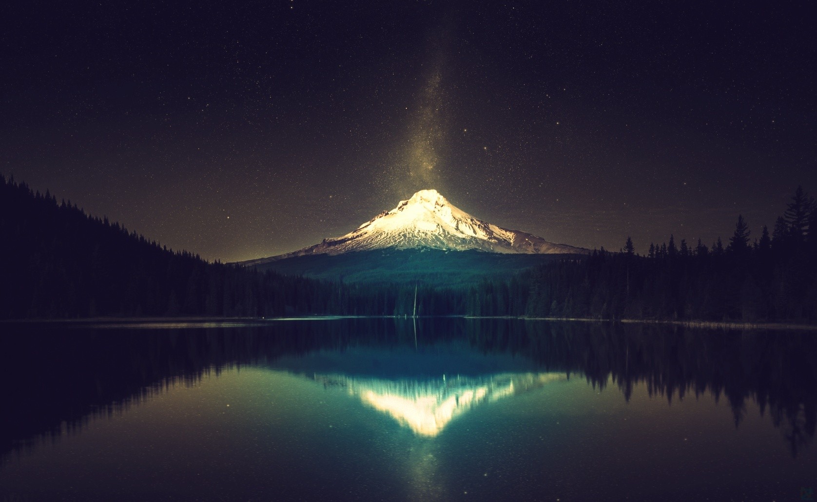 Snowy mountain at night reflected in a lake HD Wallpaper