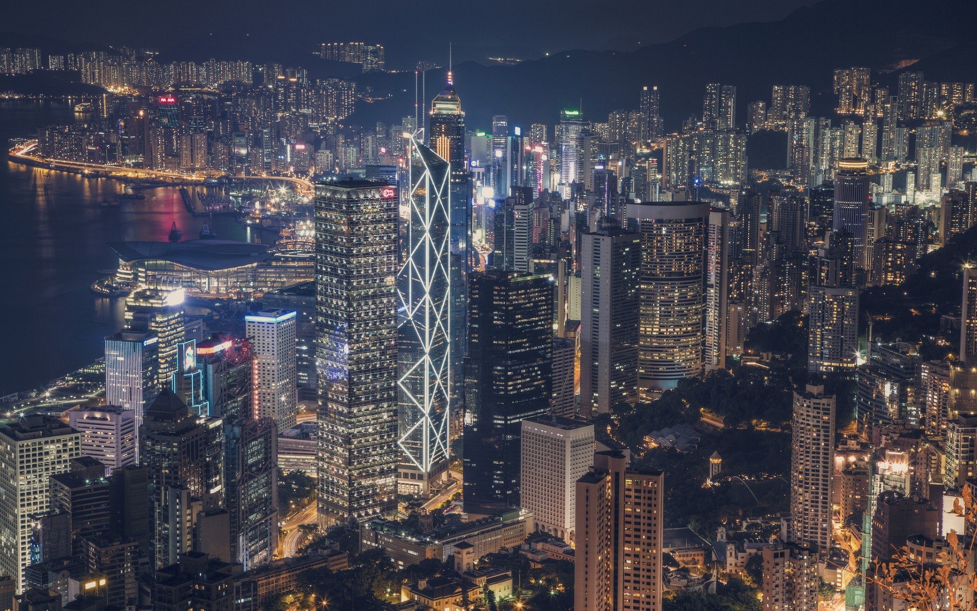 Hong Kong cityscape at night with illuminated skyscrapers HD Wallpaper