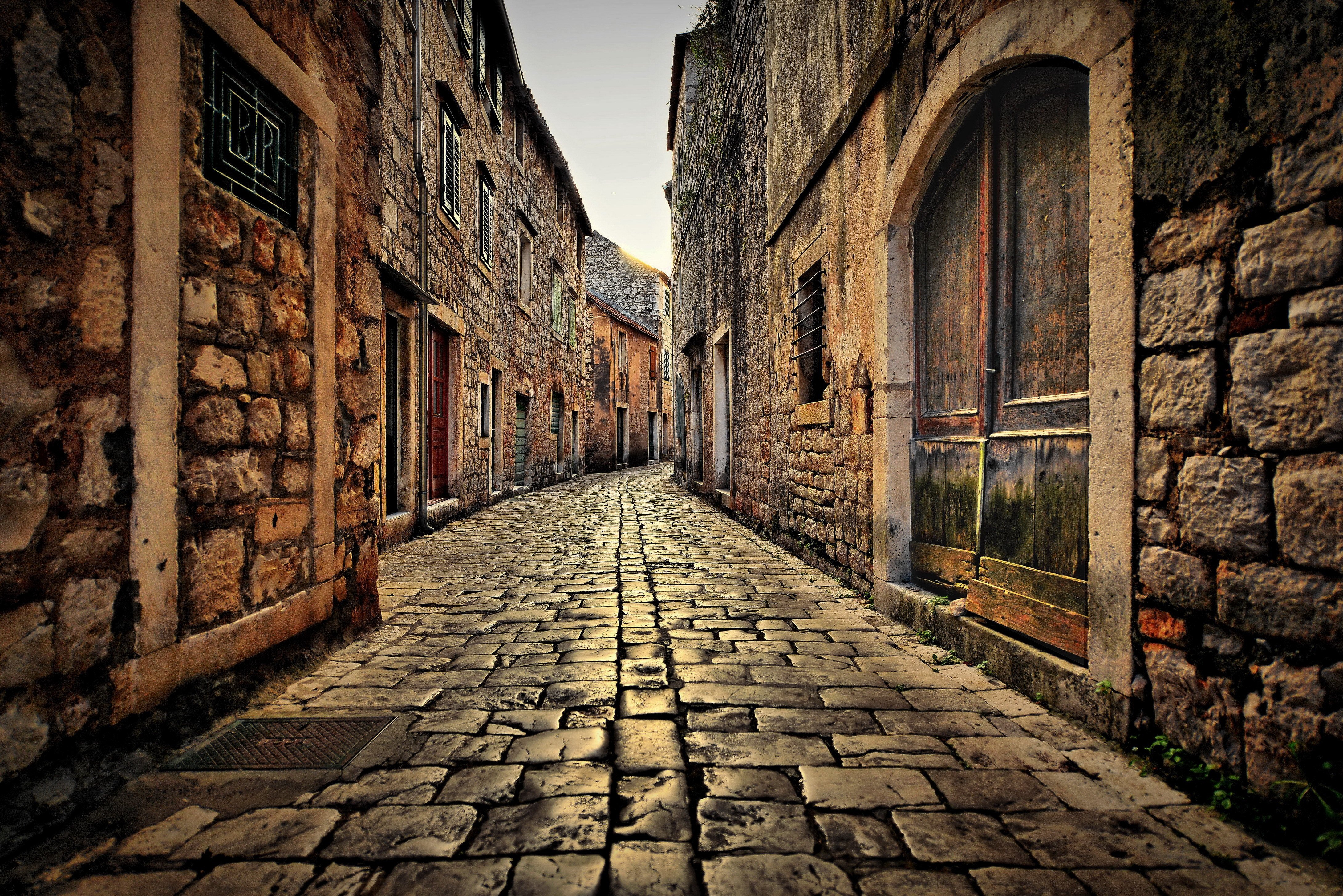 Cobblestone street in a Croatian town with stone buildings HD Wallpaper