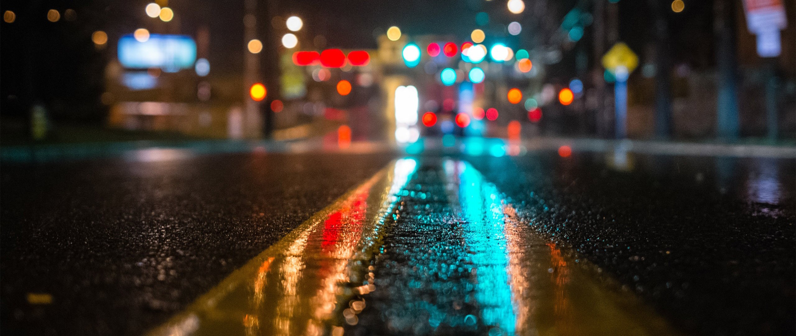 Wet city street at night with traffic lights HD Wallpaper