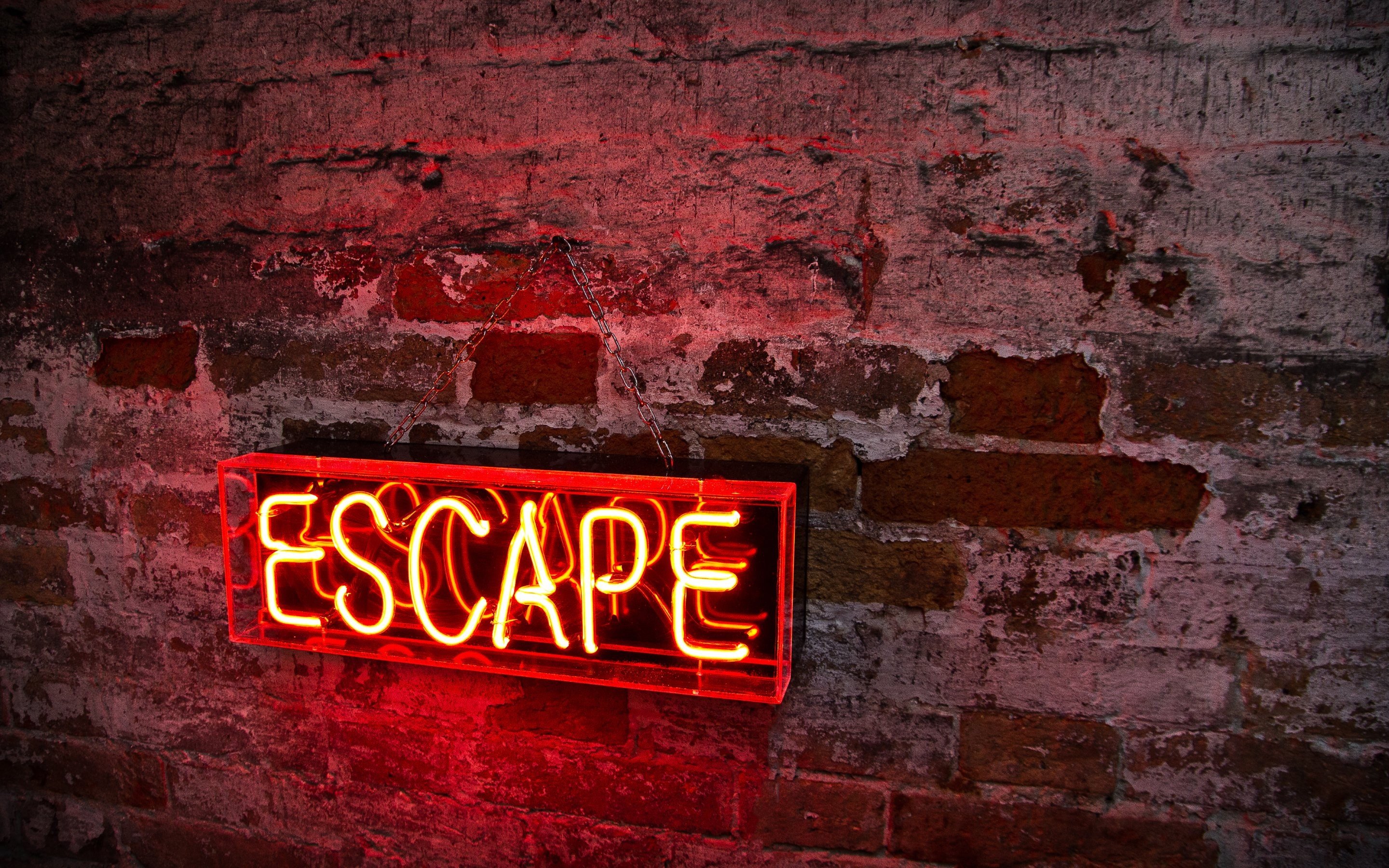 Red neon "ESCAPE" sign on brick wall HD Wallpaper
