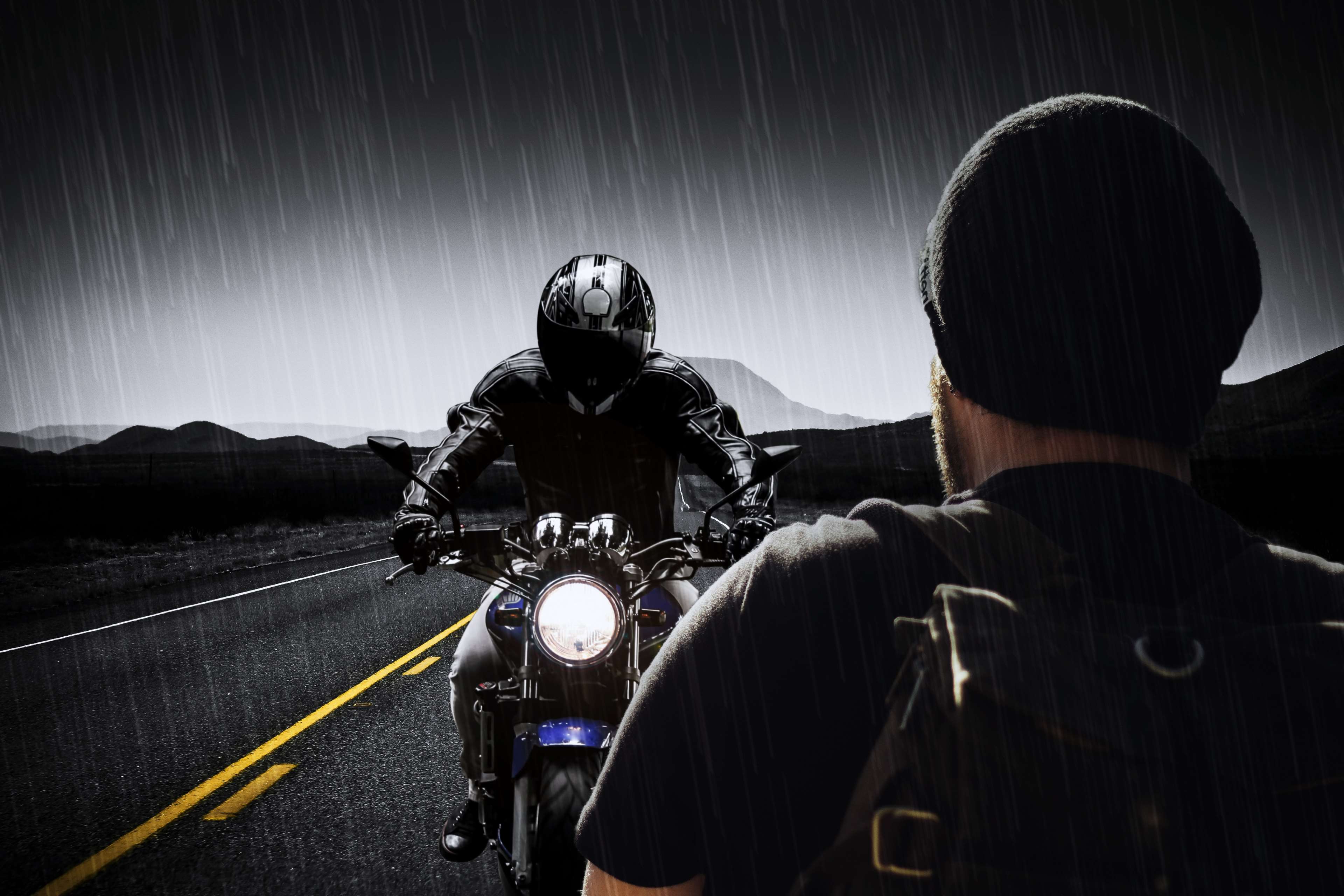 Man on motorcycle in rain on road with mountains 4K HD Wallpaper