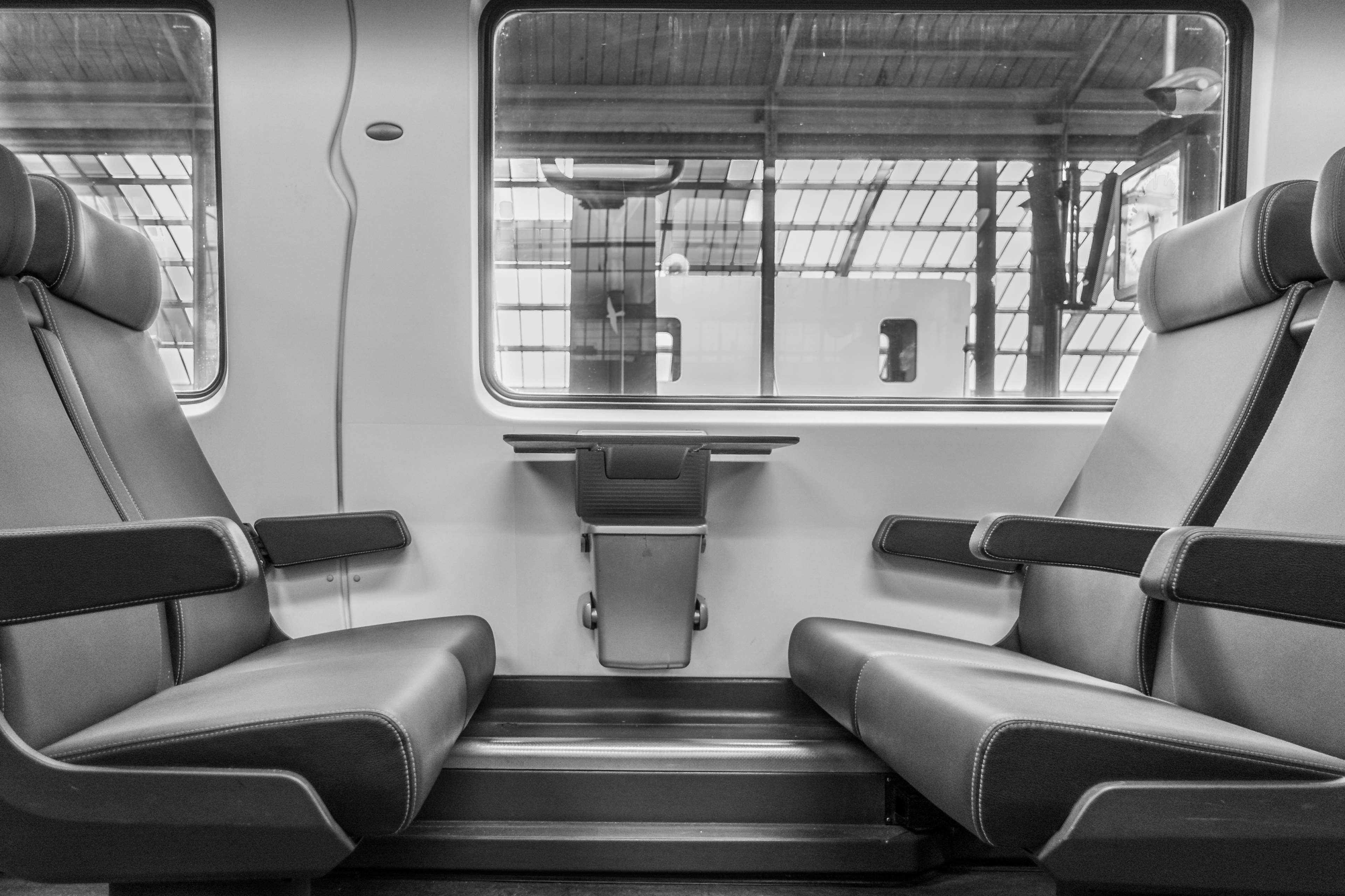Interior of a modern train with empty leather seats HD Wallpaper