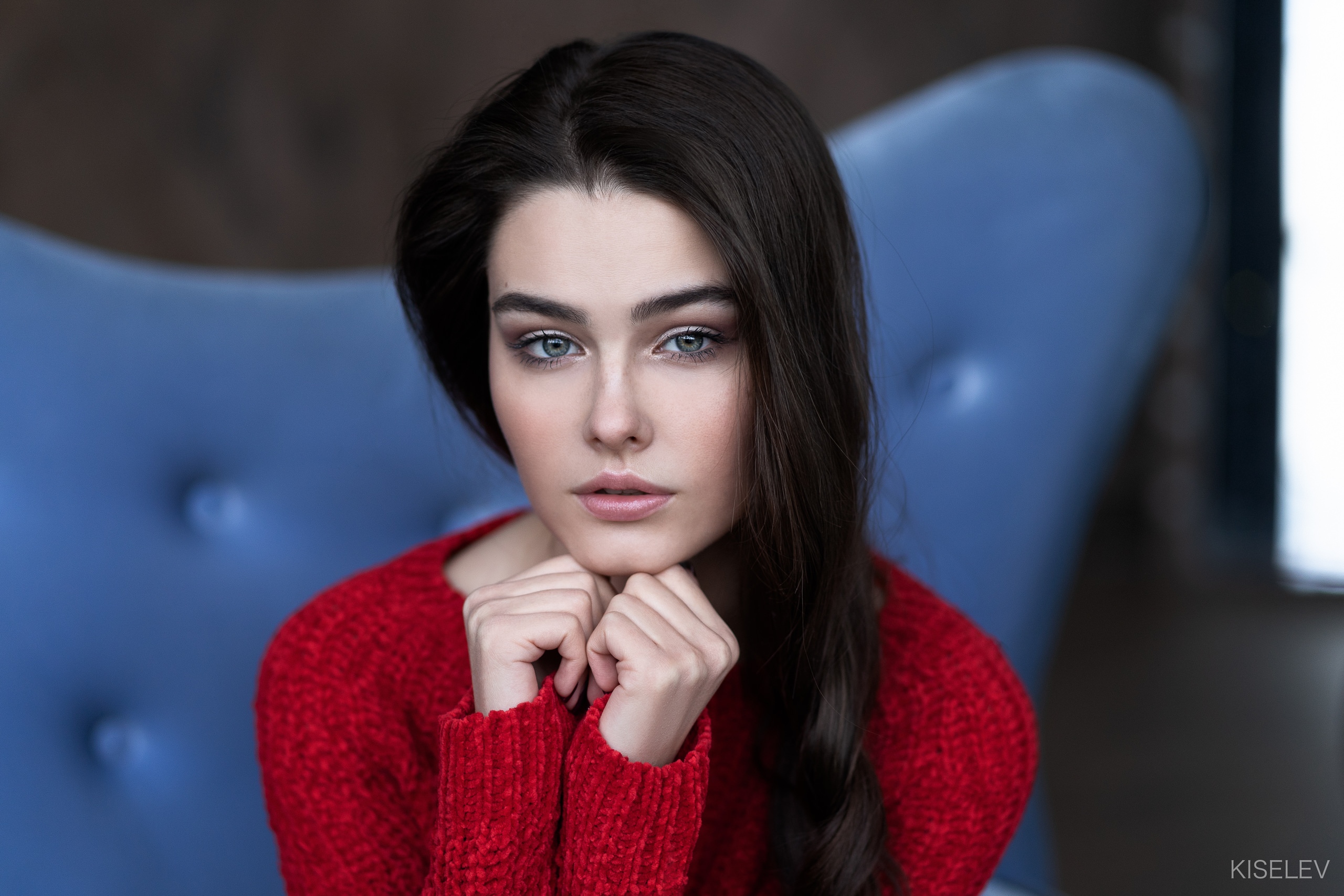 Woman in red sweater sitting on blue chair HD Wallpaper