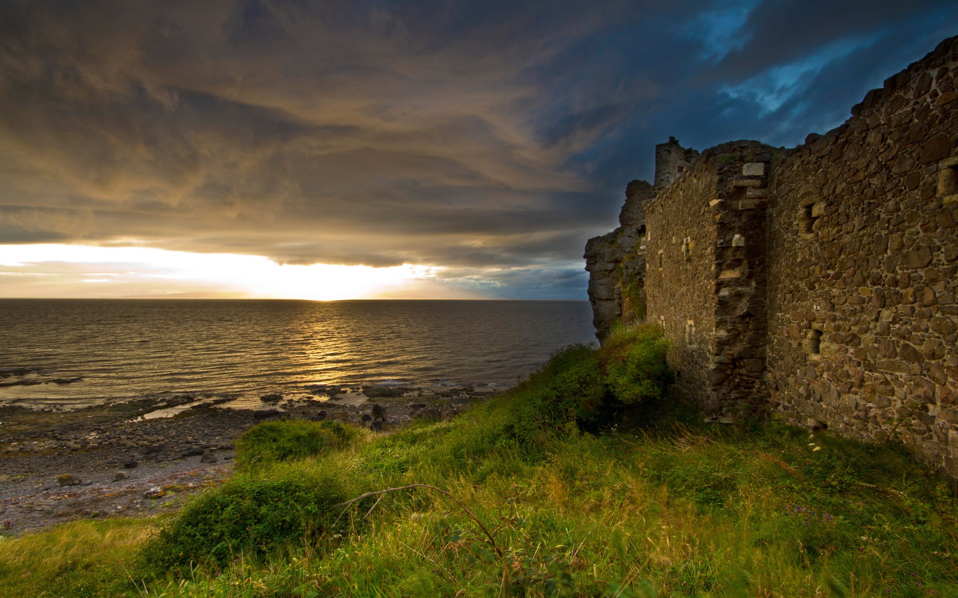 Castle ruins on a cliff overlooking the sea at sunset HD Wallpaper