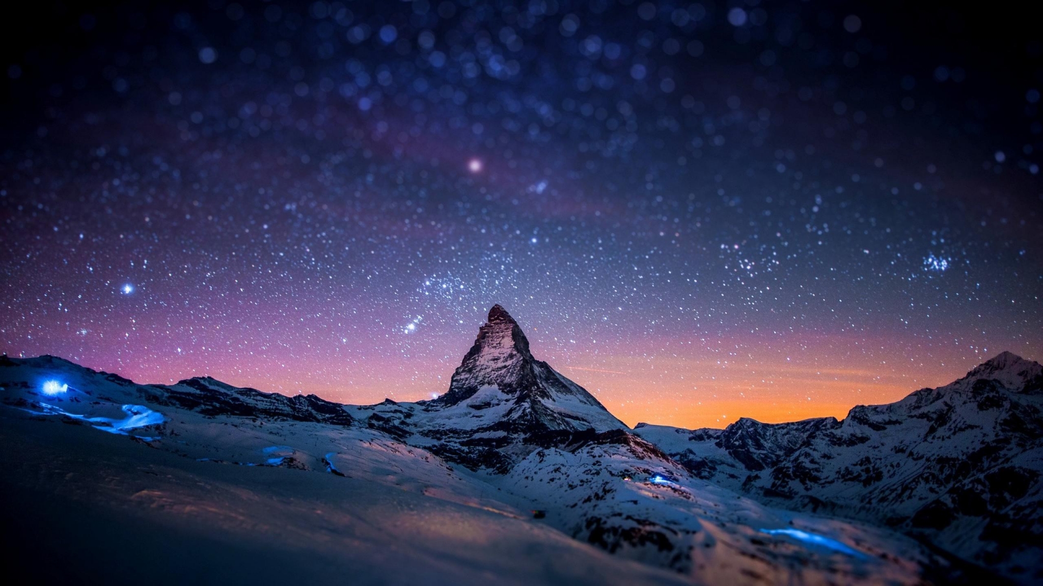 Snowy mountains under a starry night sky HD Wallpaper