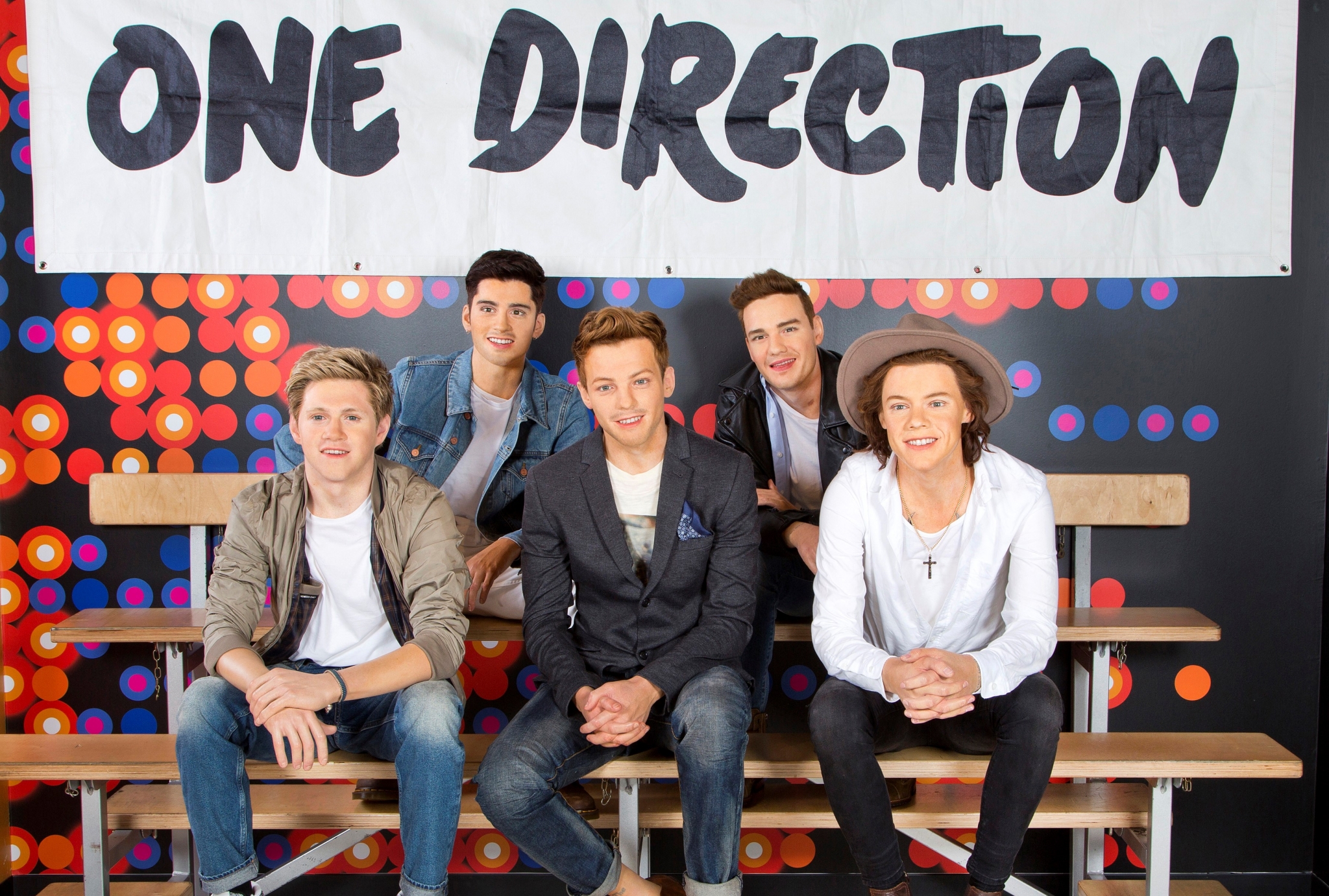 One Direction band members posing on bleachers HD Wallpaper
