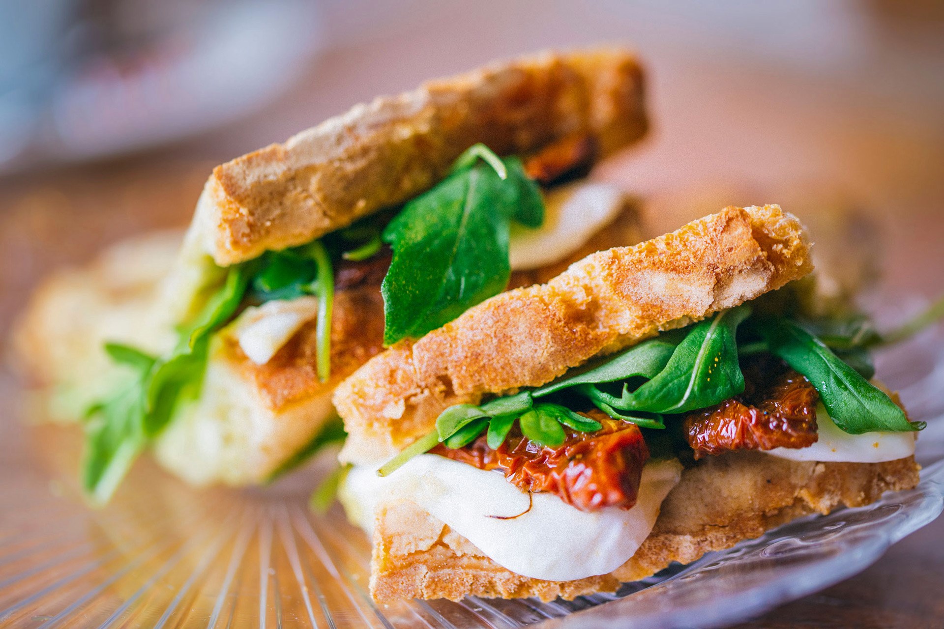 Sandwiches with mozzarella, sun-dried tomatoes, and arugula HD Wallpaper