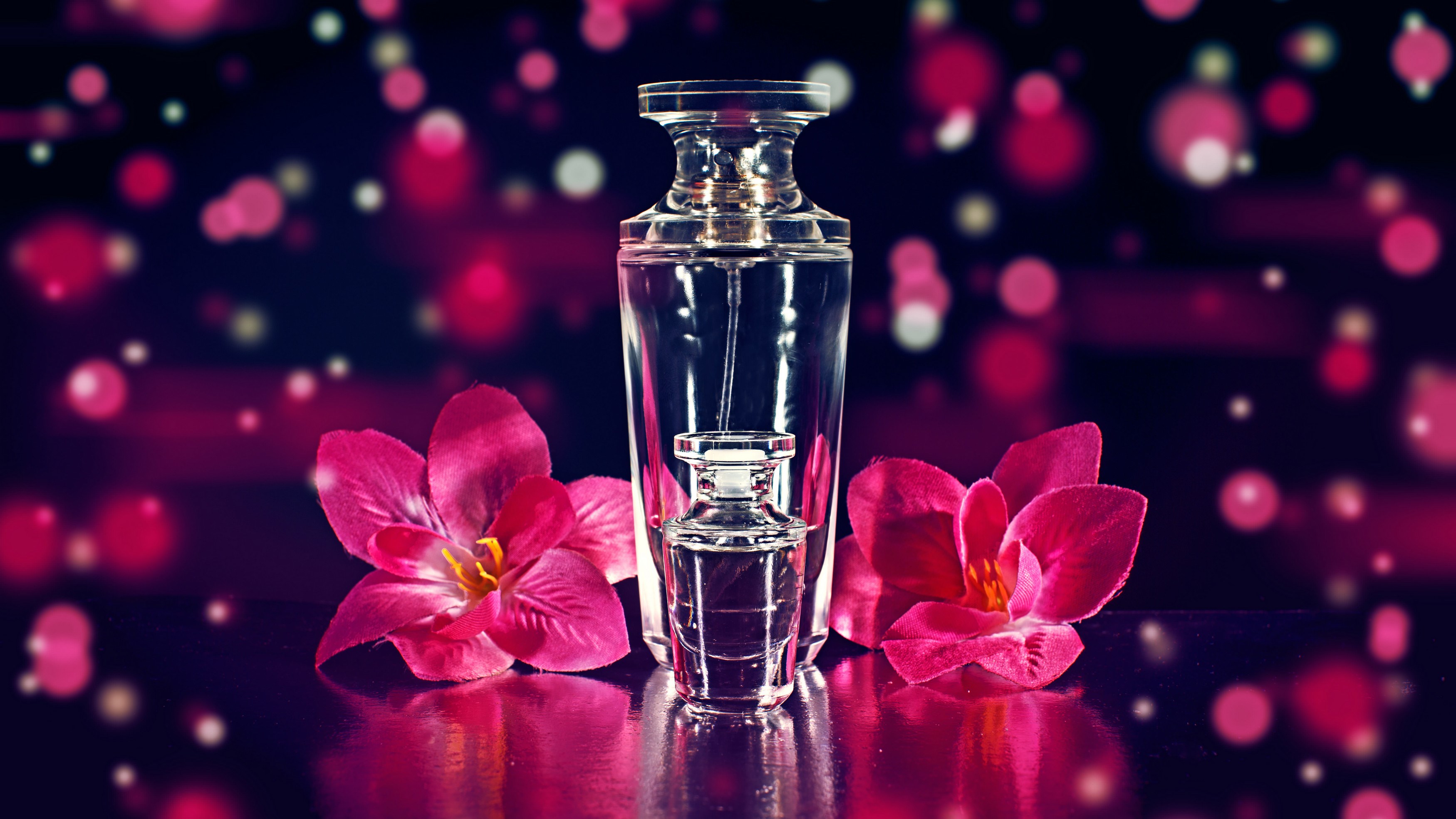 Perfume bottles with pink flowers and bokeh HD Wallpaper