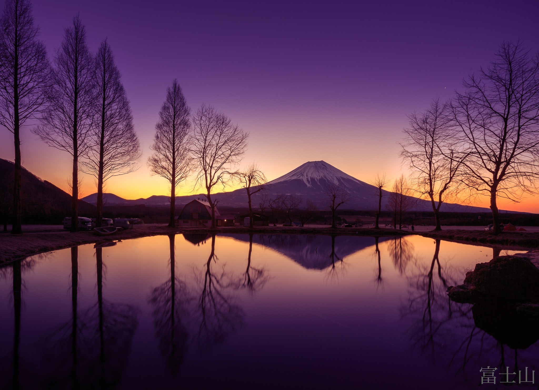 Mount Fuji reflected in a lake at sunset HD Wallpaper