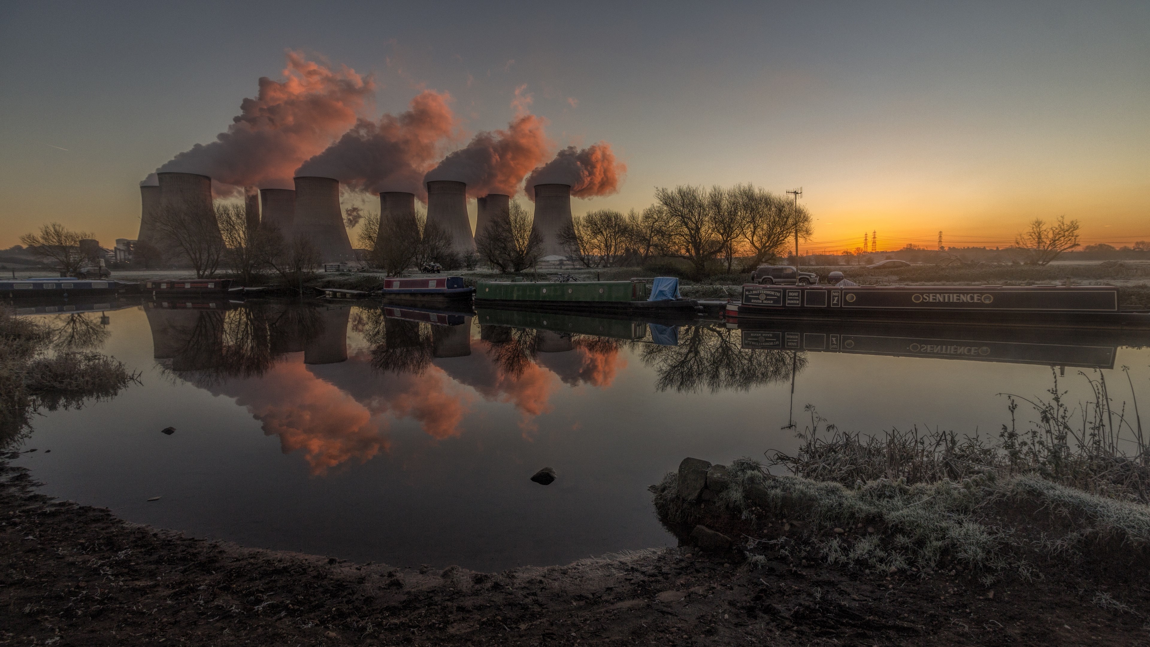 Cooling towers and canal at sunrise HD Wallpaper