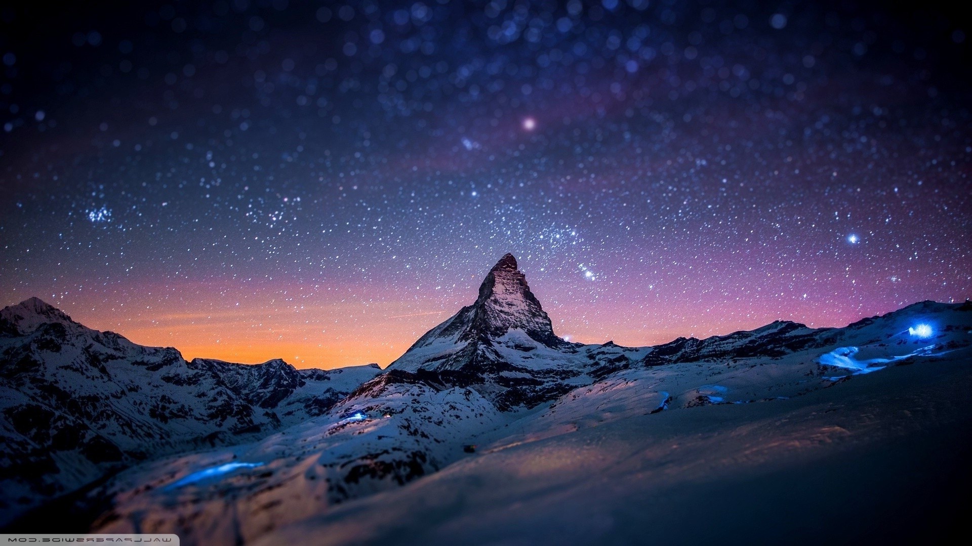 Snowy mountains under a starry night sky HD Wallpaper