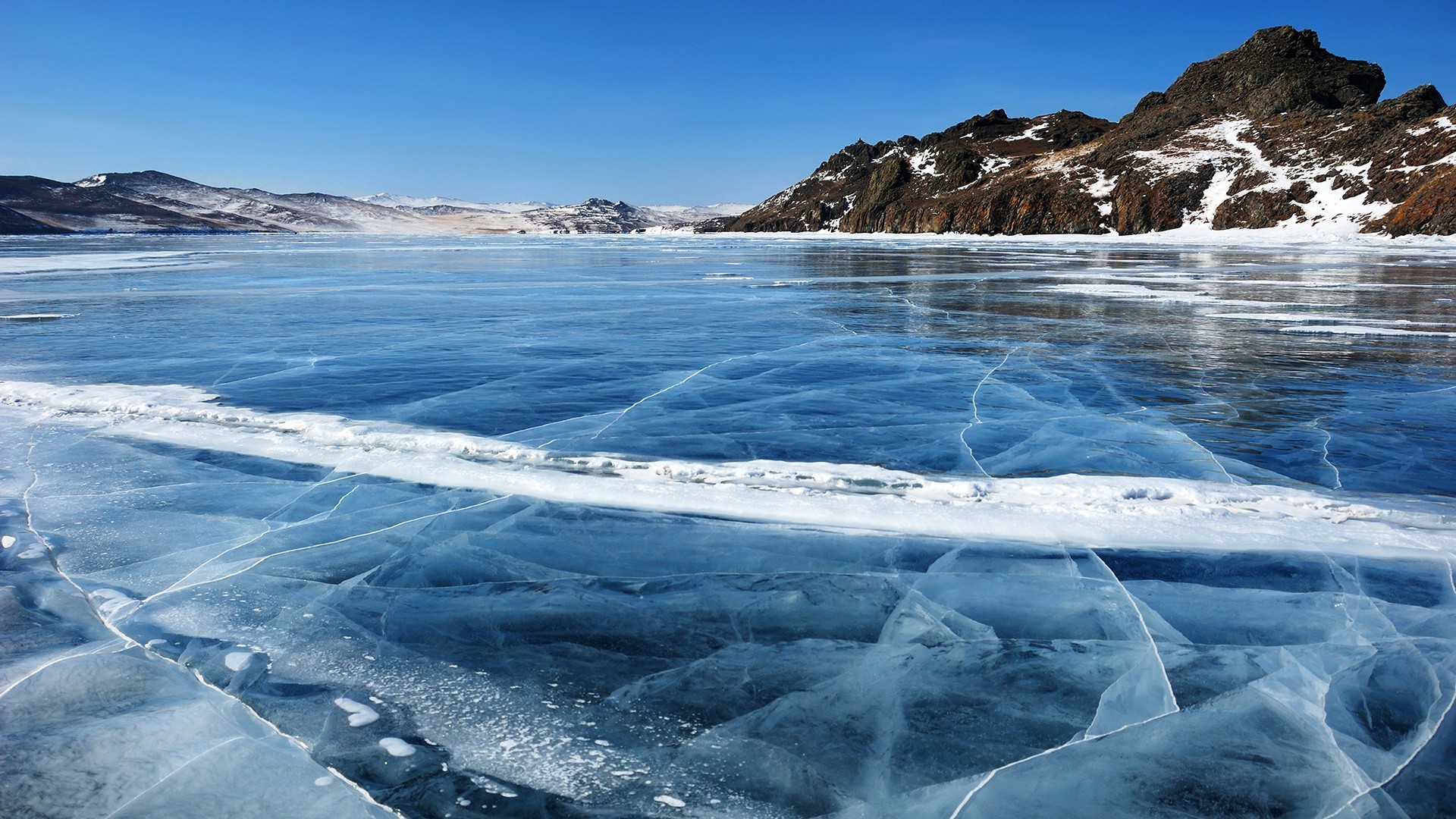 Cracked Ice Lake with Mountains Under Blue Sky HD Wallpaper