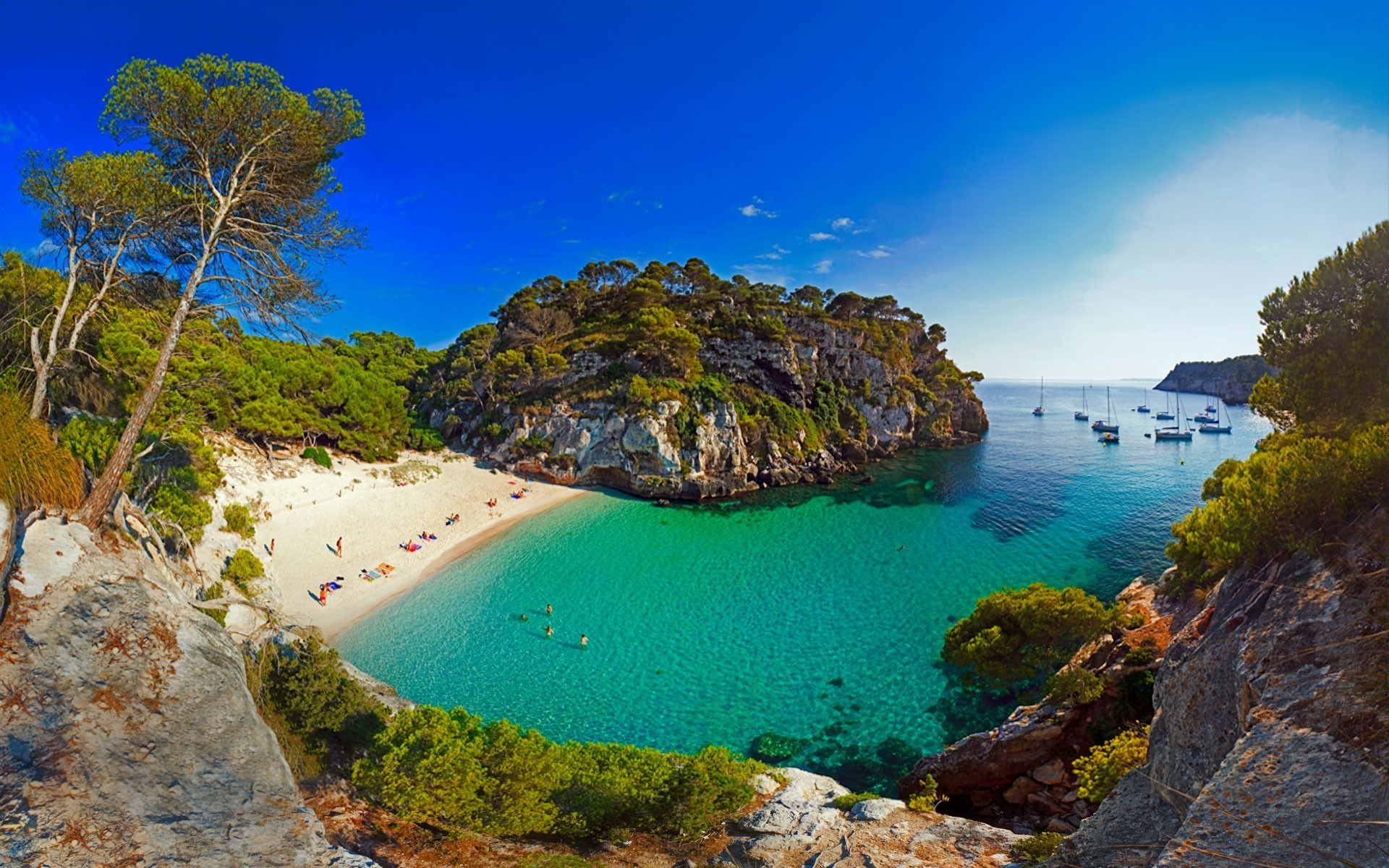Beautiful beach with turquoise water and boats in Spain HD Wallpaper