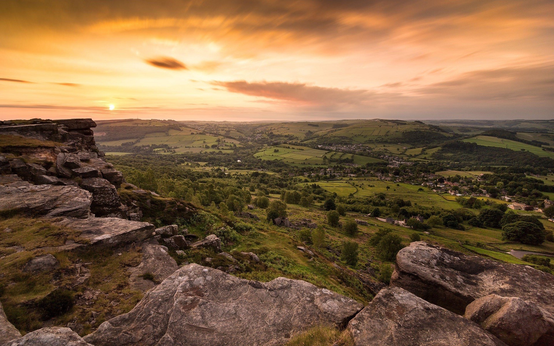 Rocky outcrop overlooking a valley at sunset HD Wallpaper